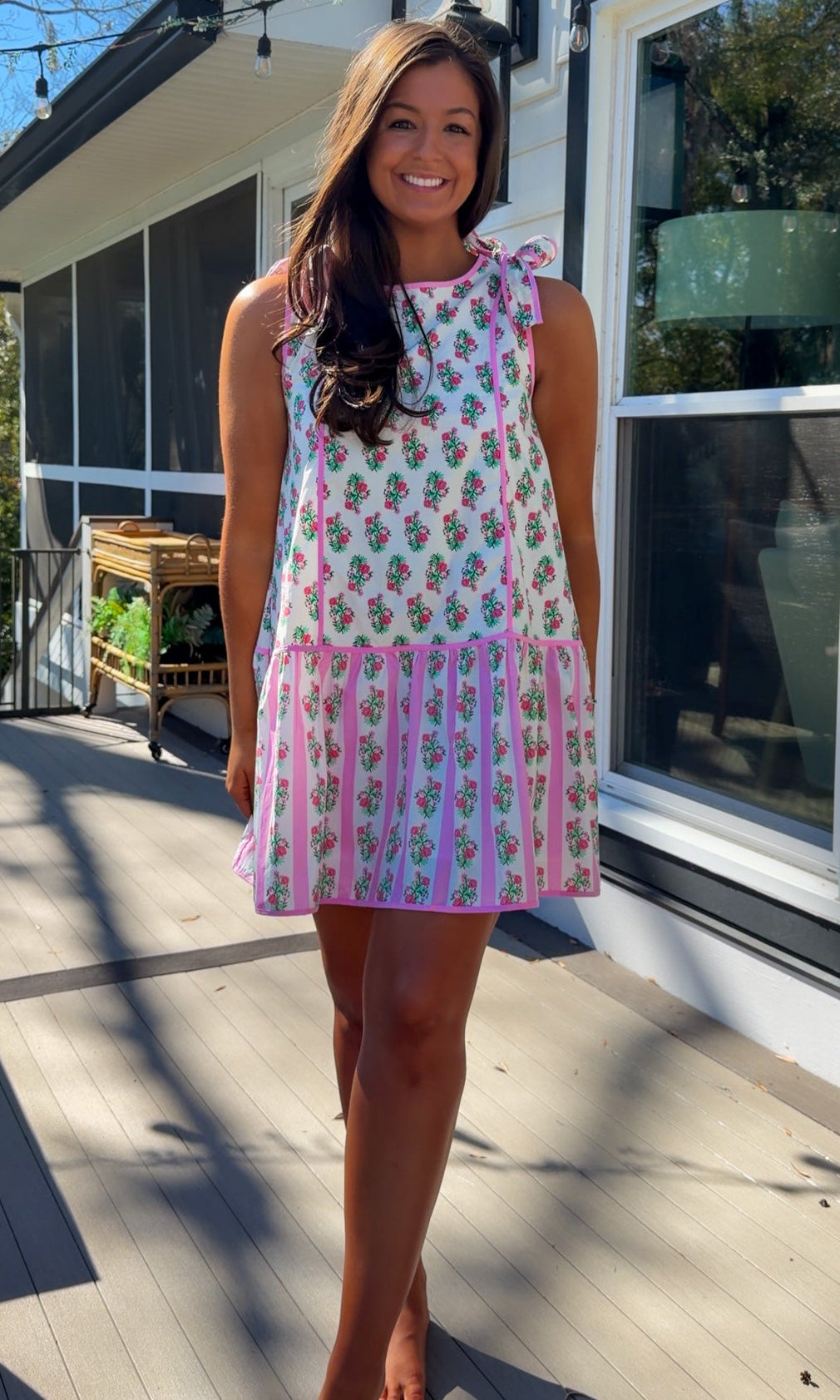 pink floral mini dress with ruffle hem and decorative shoulder bows