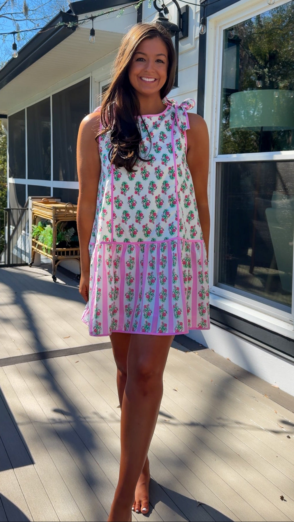 pink floral mini dress with ruffle hem and decorative shoulder bows