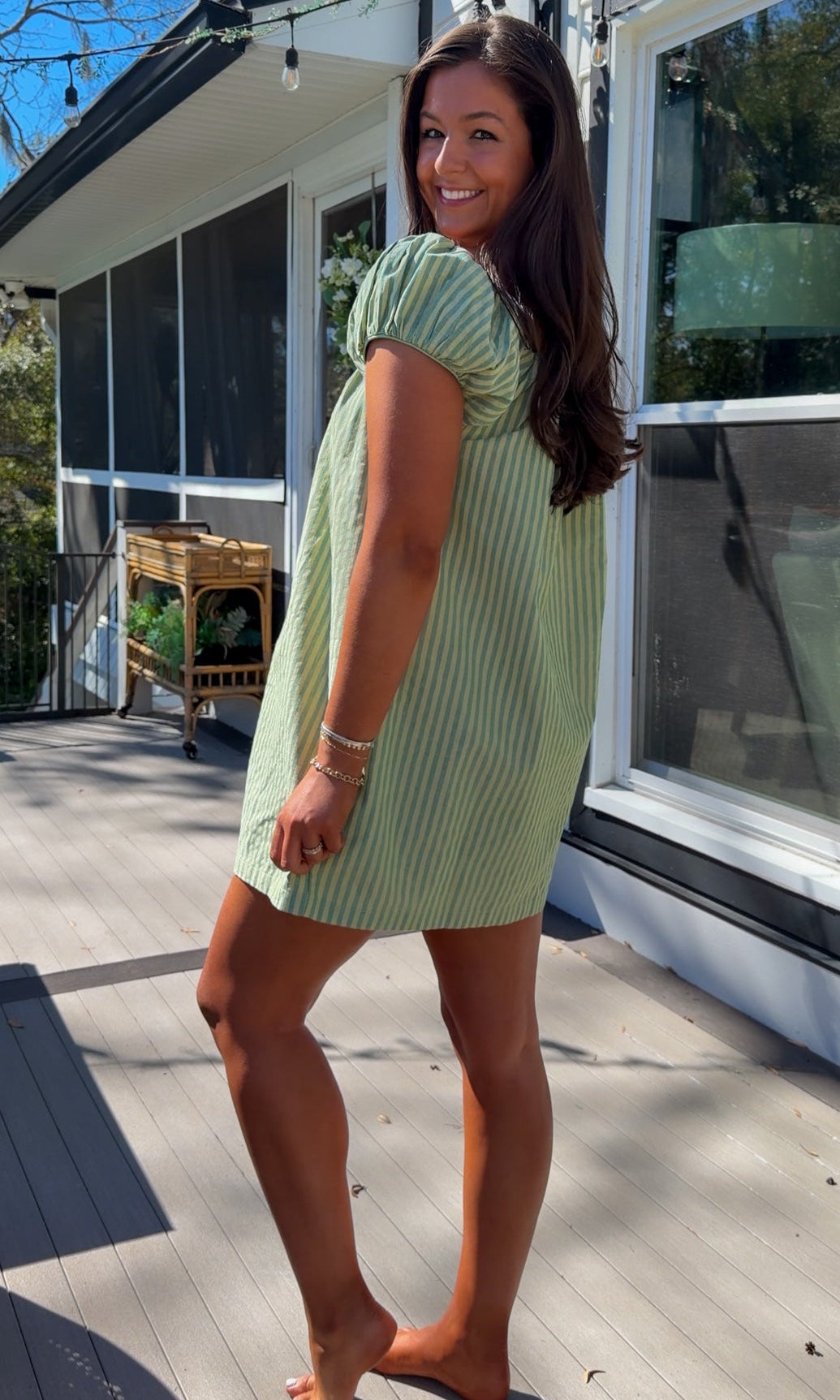 green striped babydoll mini dress with gathered neckline and pockets