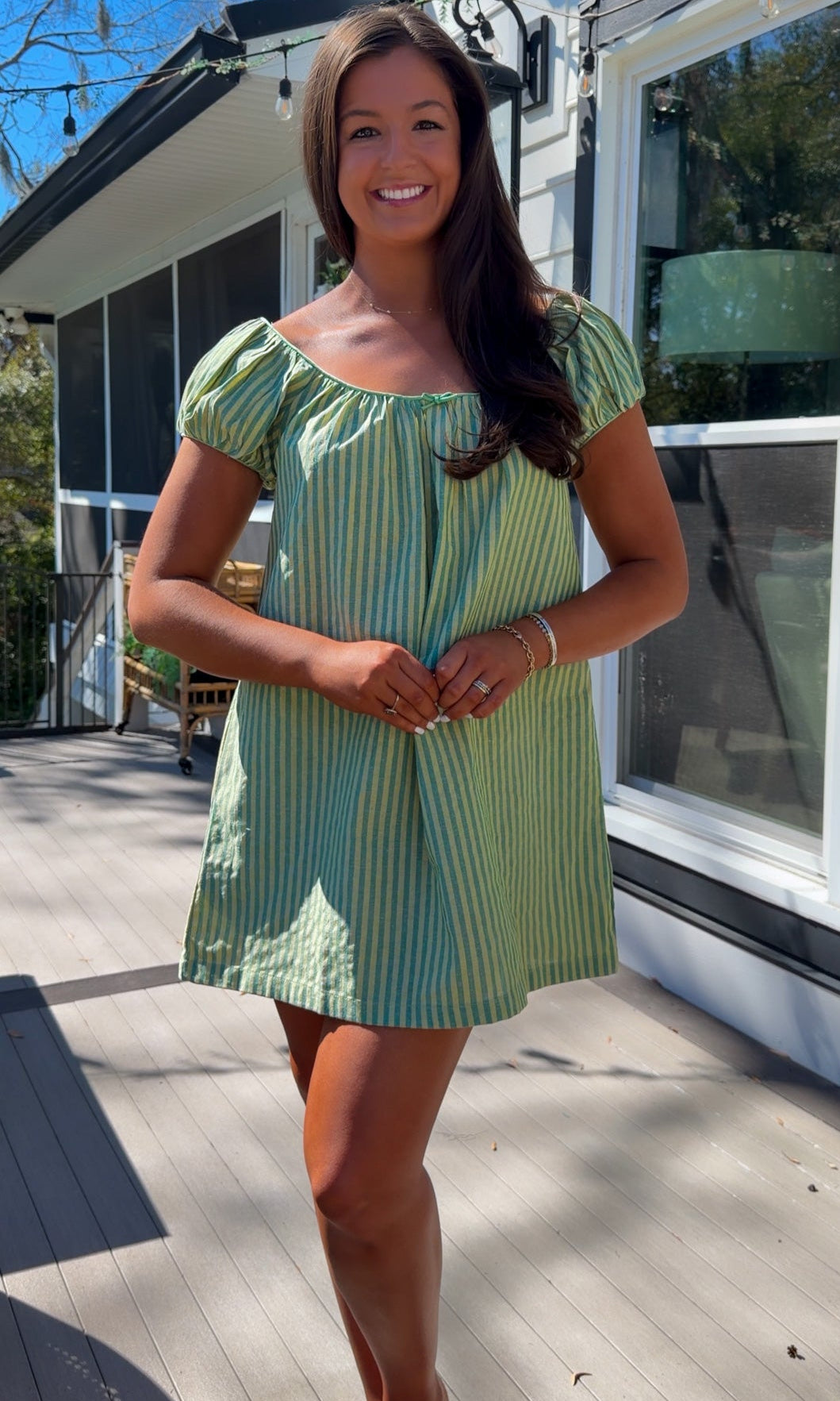 green striped babydoll mini dress with gathered neckline and pockets