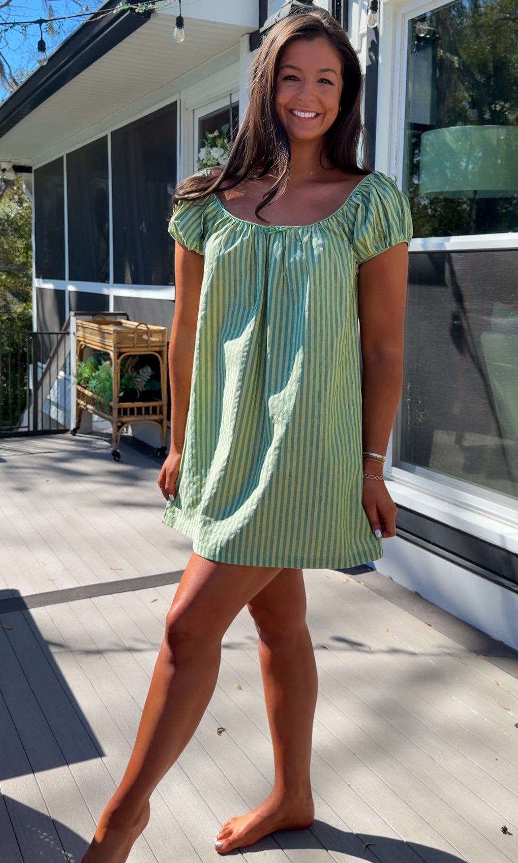 green striped babydoll mini dress with gathered neckline and pockets