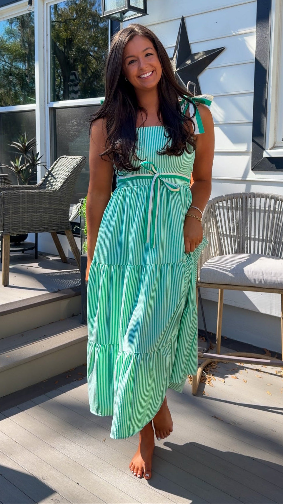 green striped tiered midi dress with bow tie straps and smocked back