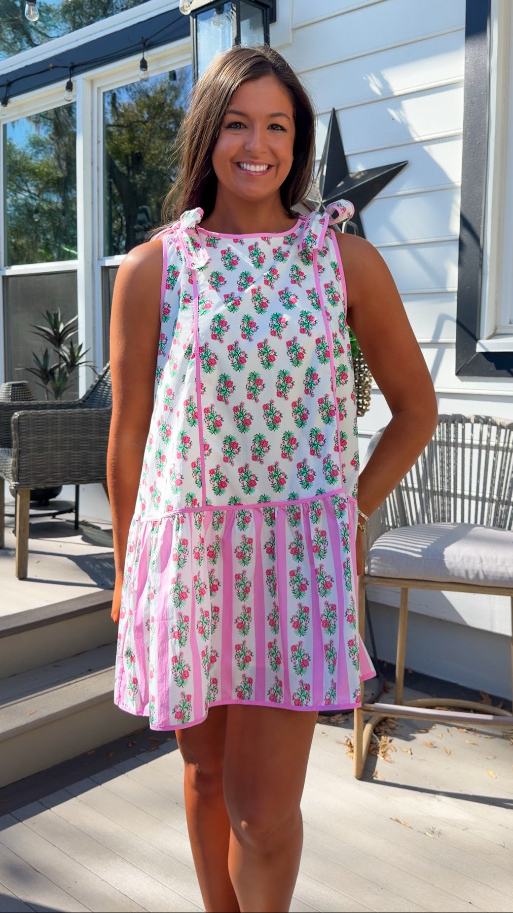 pink floral mini dress with ruffle hem and decorative shoulder bows