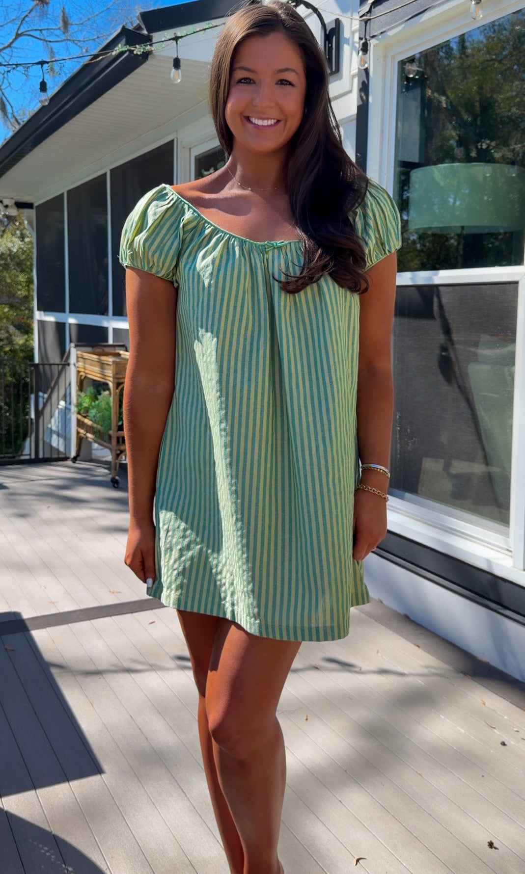 green striped babydoll mini dress with gathered neckline and pockets