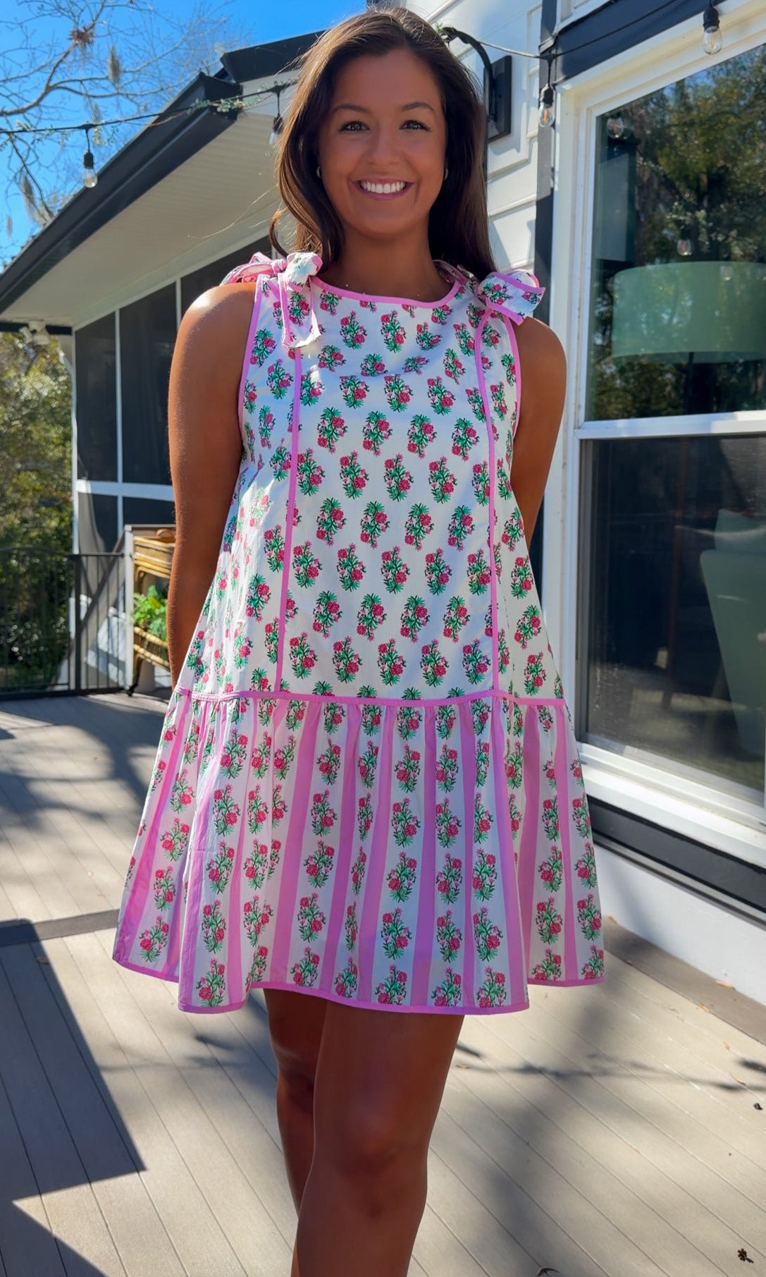 pink floral mini dress with ruffle hem and decorative shoulder bows