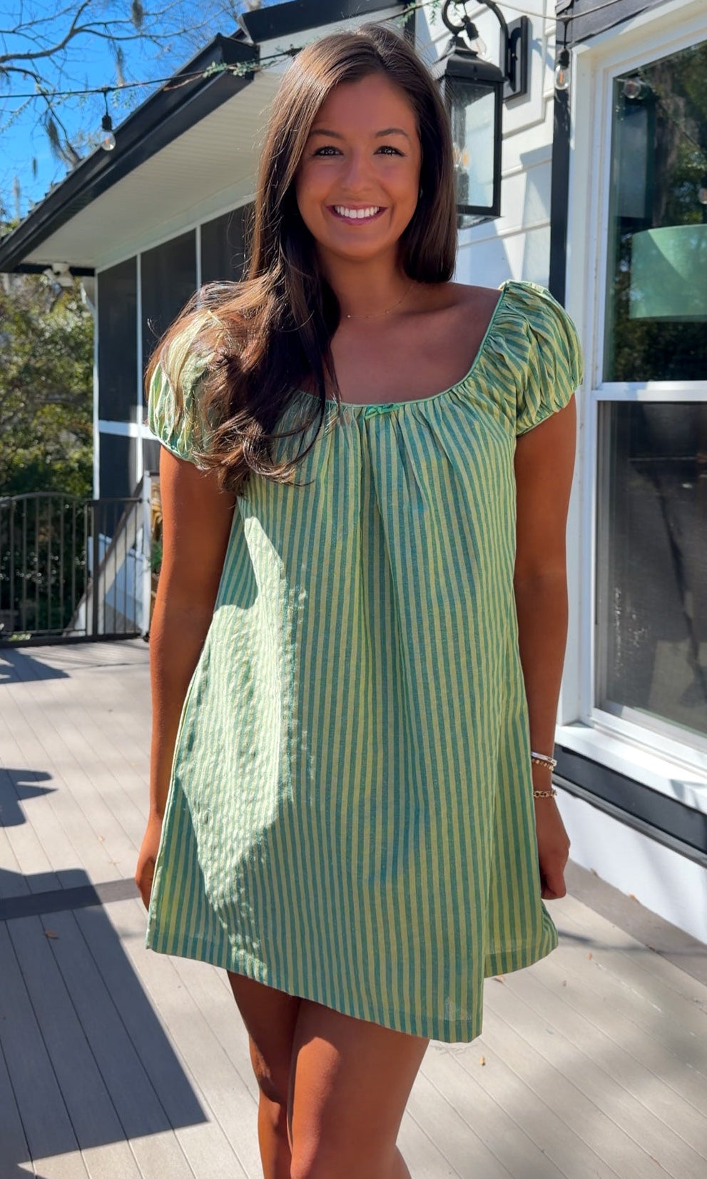 green striped babydoll mini dress with gathered neckline and pockets