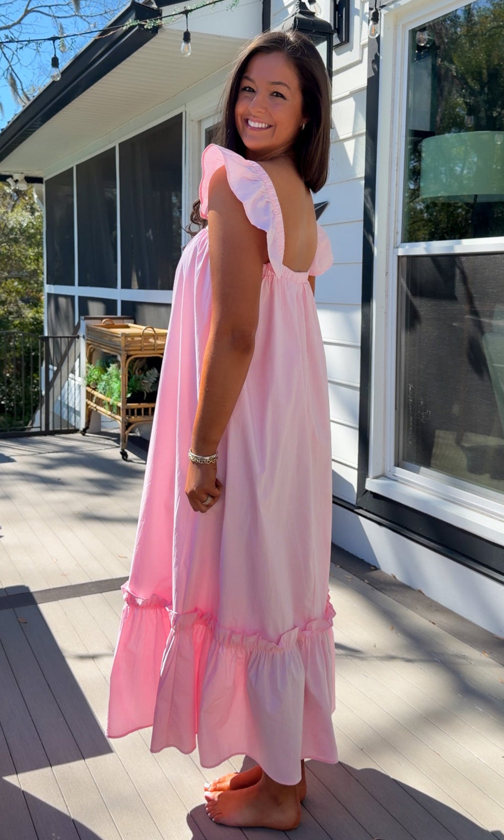 baby pink midi dress with flutter sleeves and tiered ruffle hem