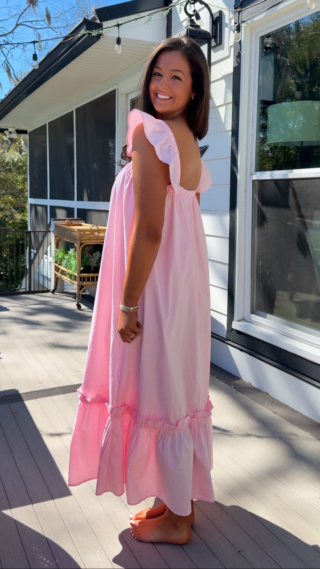 baby pink midi dress with flutter sleeves and tiered ruffle hem