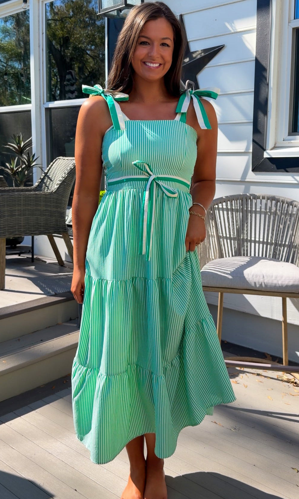 green striped tiered midi dress with bow tie straps and smocked back