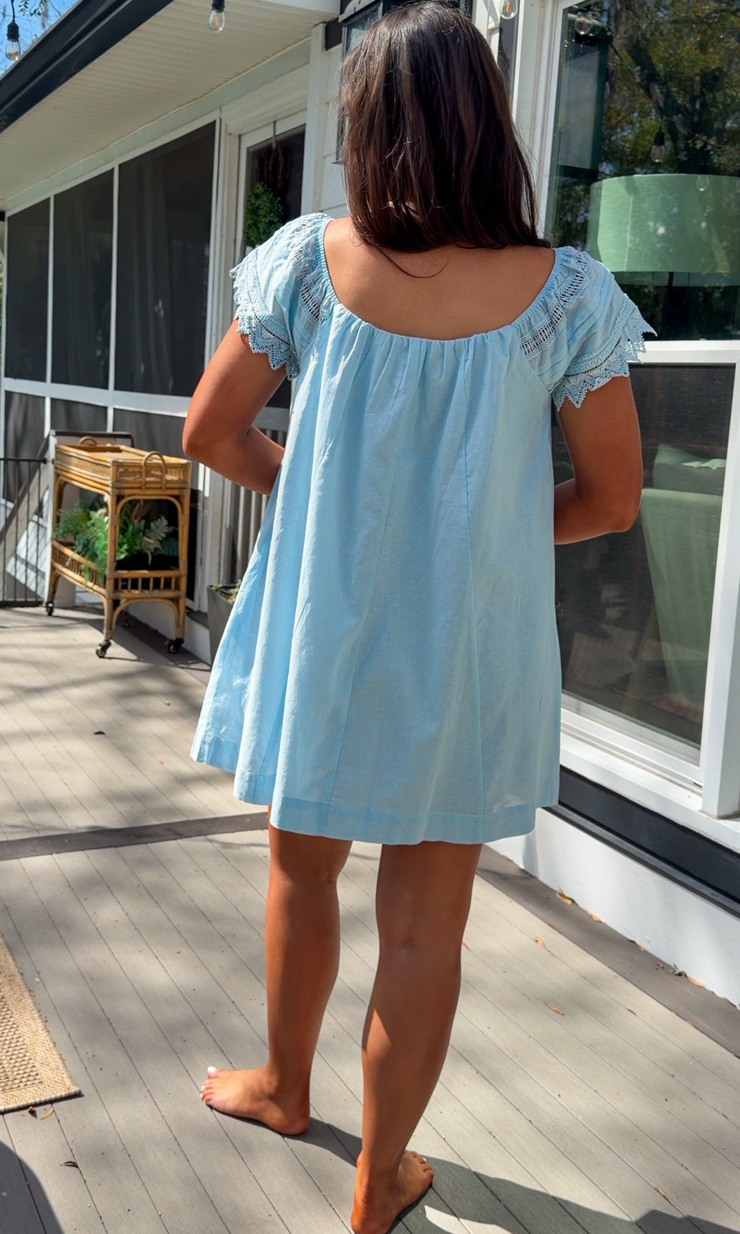 light blue linen blend mini dress with eyelet lace trim sleeves and tie neckline