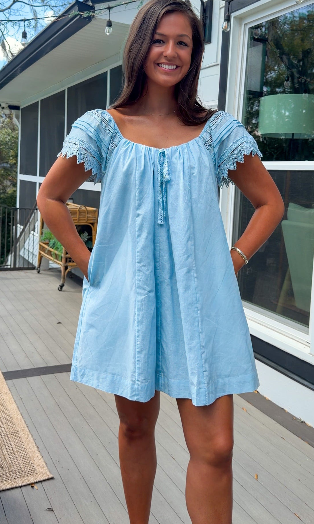 light blue linen blend mini dress with eyelet lace trim sleeves and tie neckline
