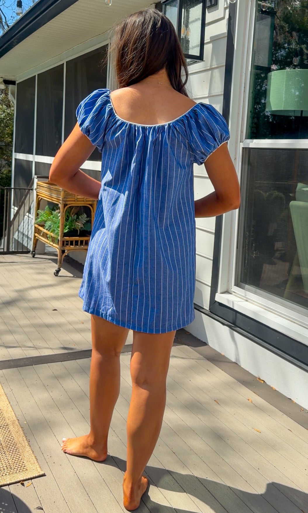 blue stripe babydoll mini dress with gathered neckline short sleeves and side pockets