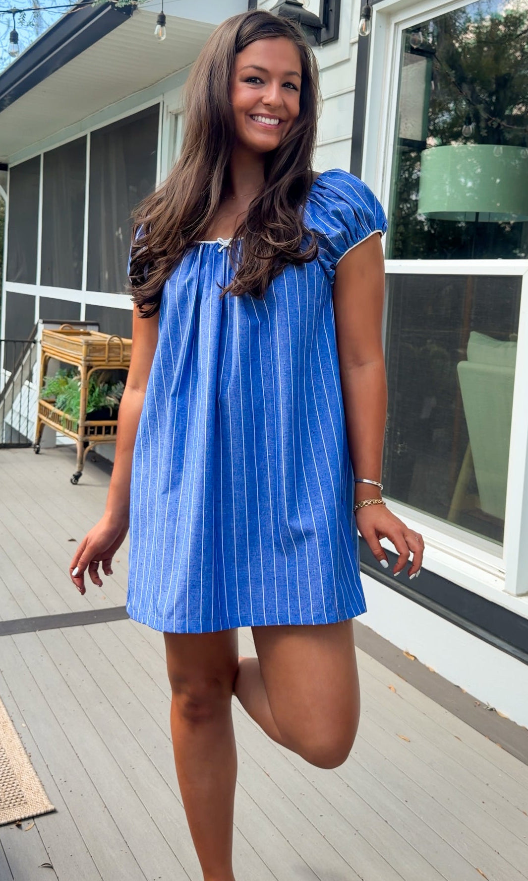 blue stripe babydoll mini dress with gathered neckline short sleeves and side pockets