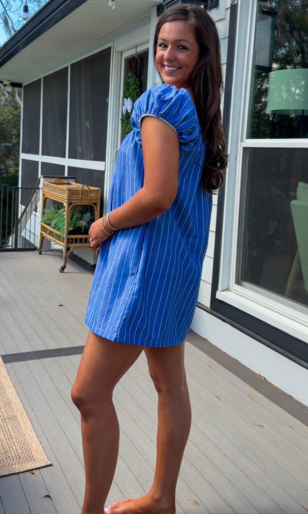 blue stripe babydoll mini dress with gathered neckline short sleeves and side pockets