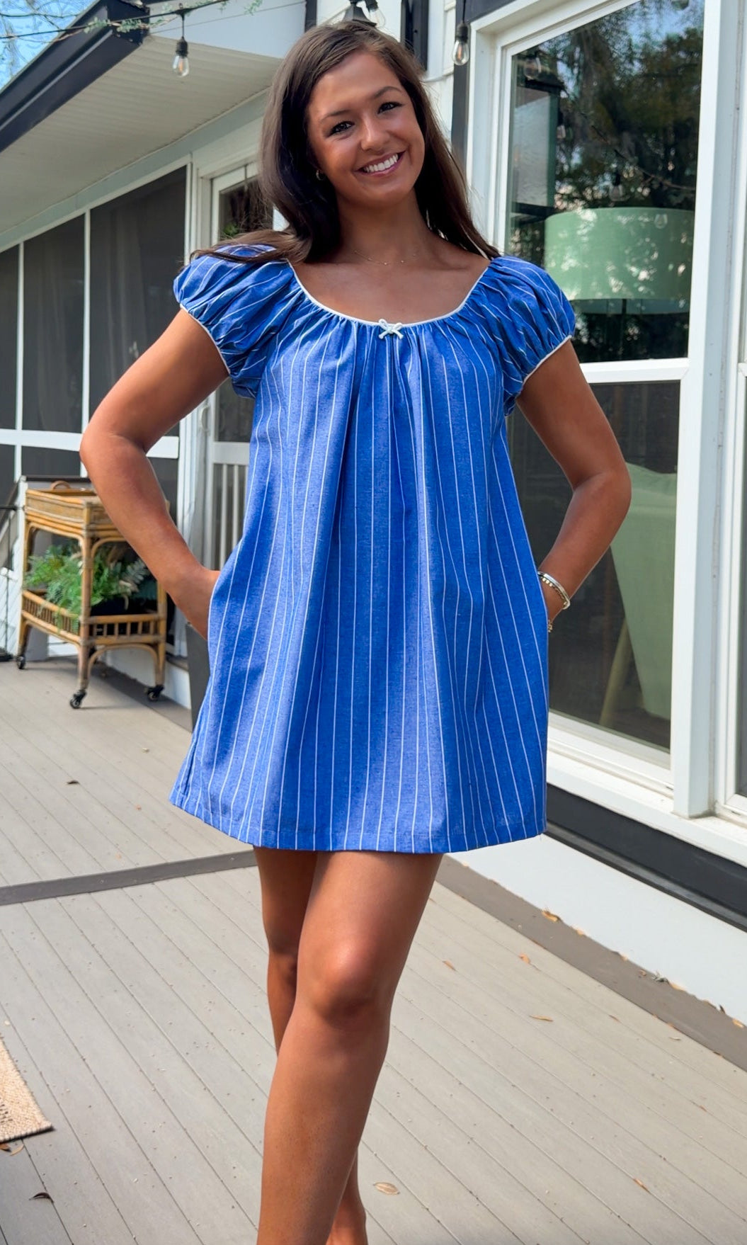 blue stripe babydoll mini dress with gathered neckline short sleeves and side pockets
