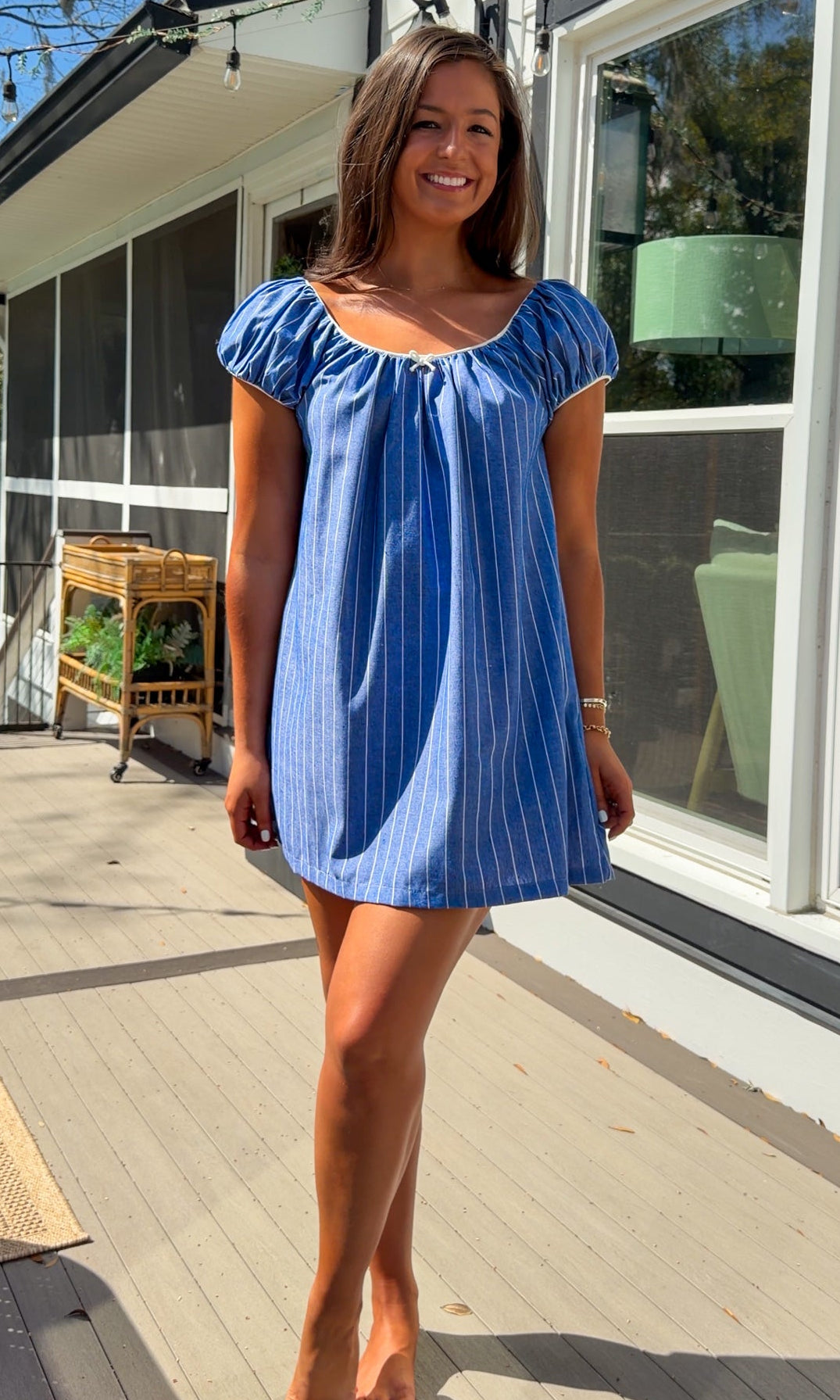 blue stripe babydoll mini dress with gathered neckline short sleeves and side pockets