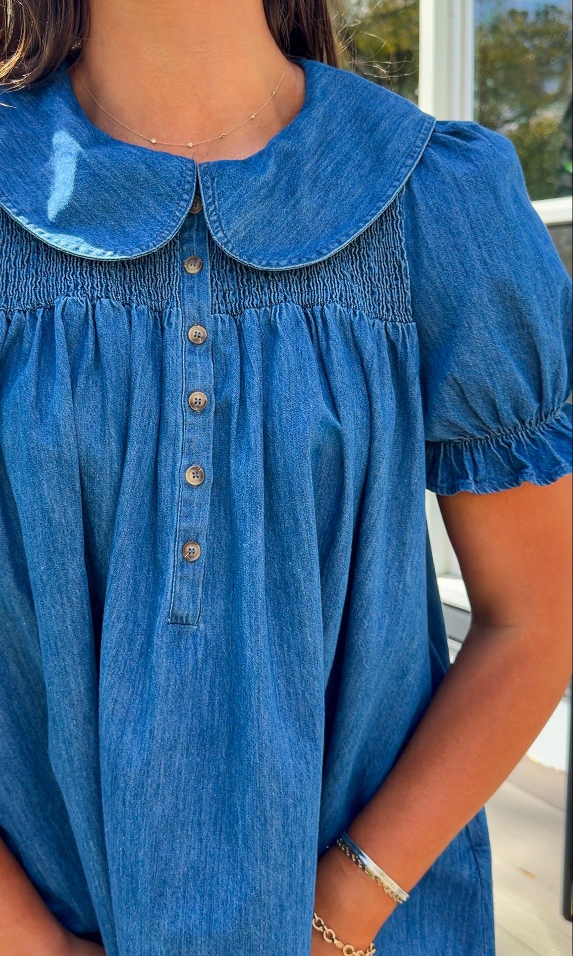 denim mini dress with peter pan collar puff sleeves button front and smocked back detail