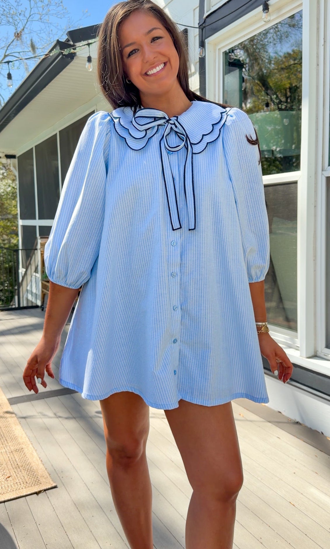 light blue striped mini dress with scalloped collar contrast trim bow tie and button front