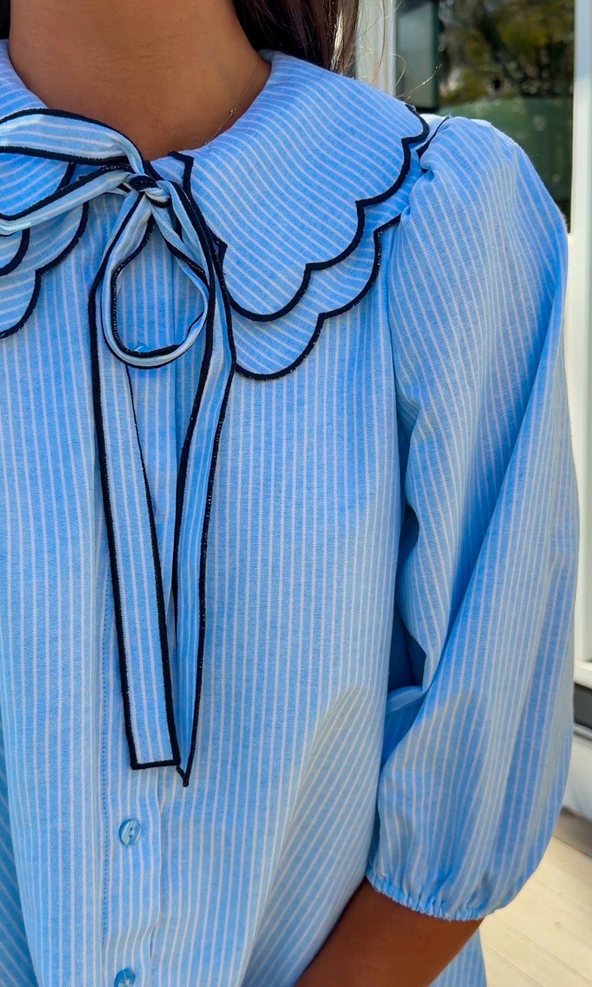 light blue striped mini dress with scalloped collar contrast trim bow tie and button front