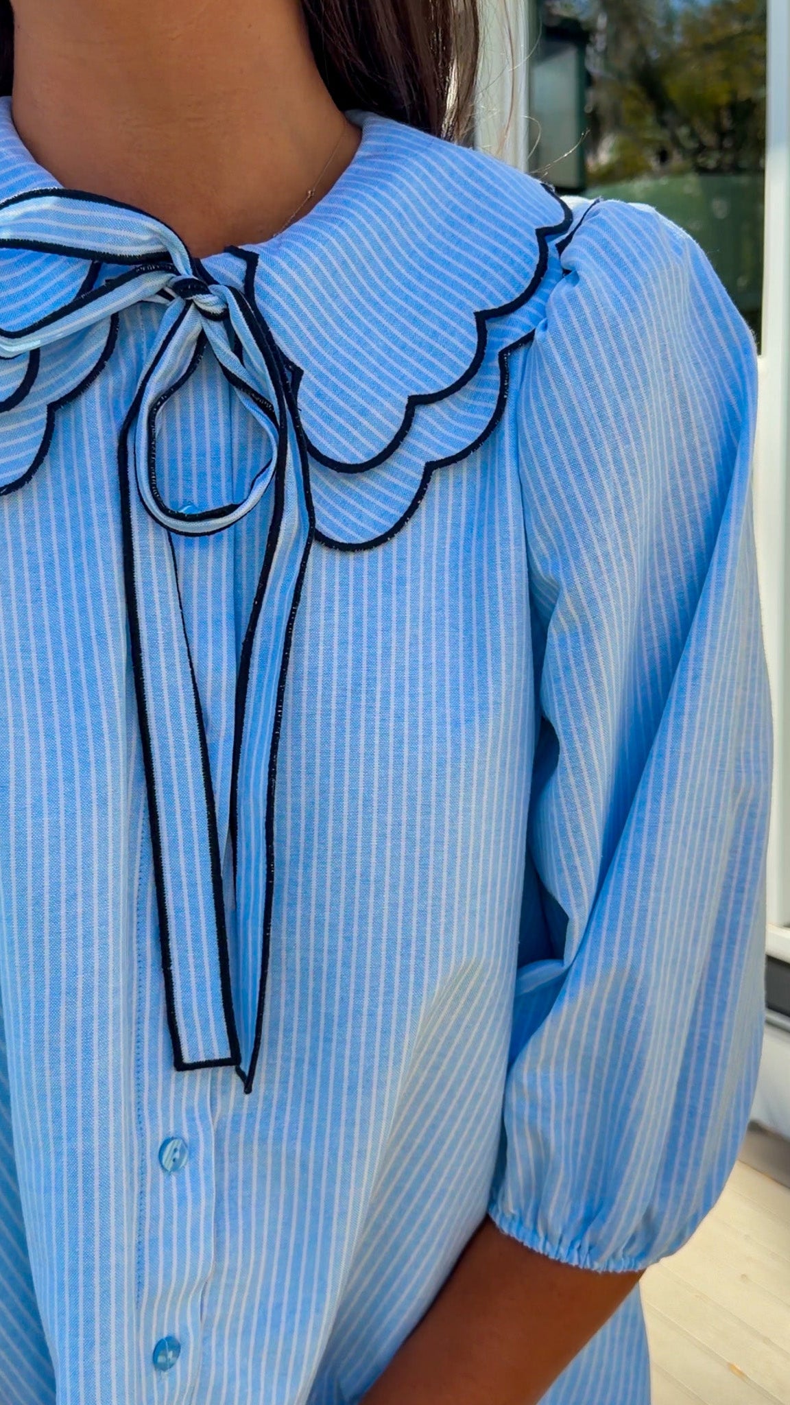 light blue striped mini dress with scalloped collar contrast trim bow tie and button front