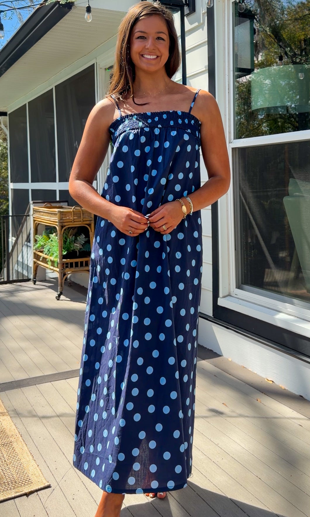 midnight blue polka dot maxi dress with smocked bodice and adjustable spaghetti straps