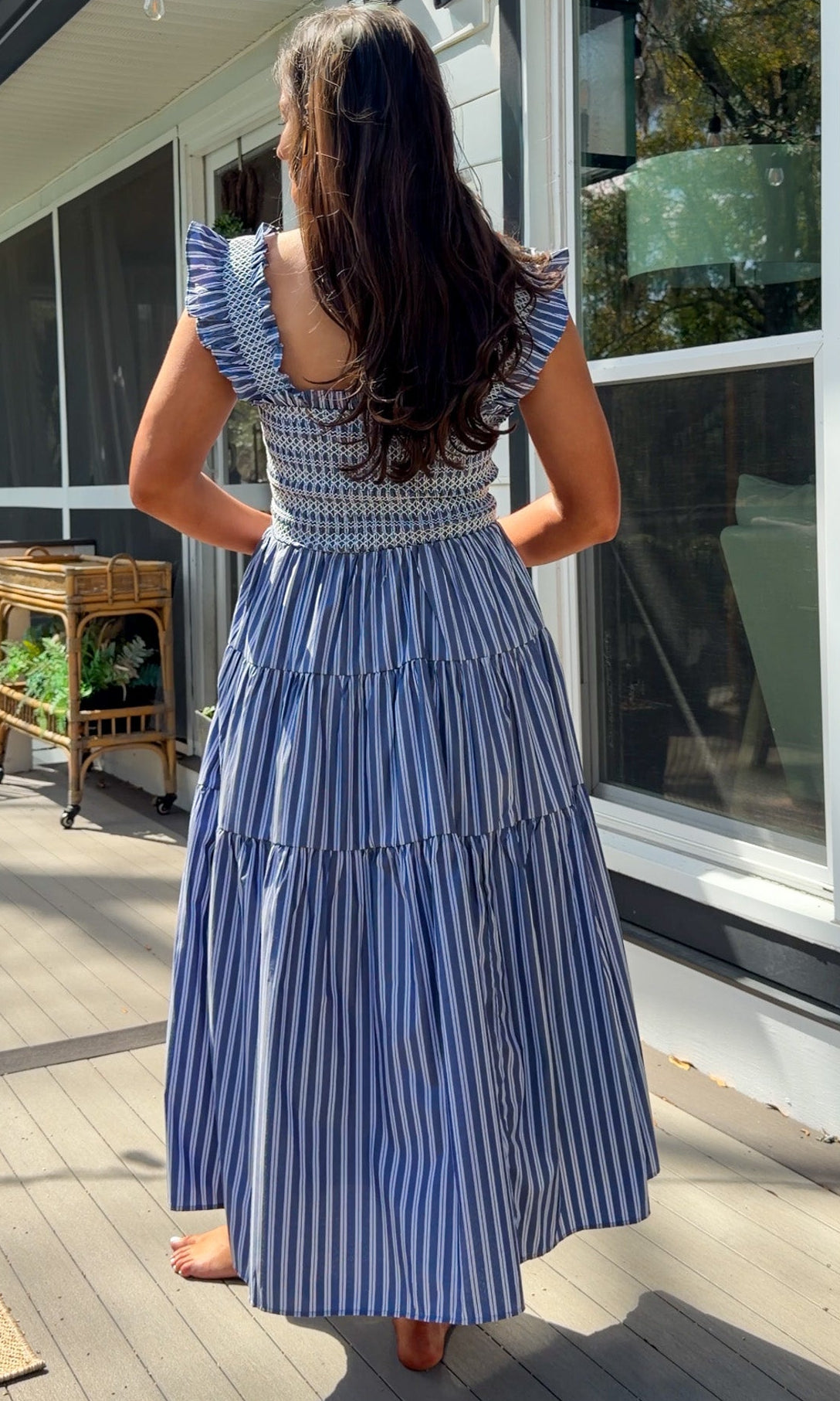 navy striped midi dress with smocked bodice ruffle sleeves and tiered skirt