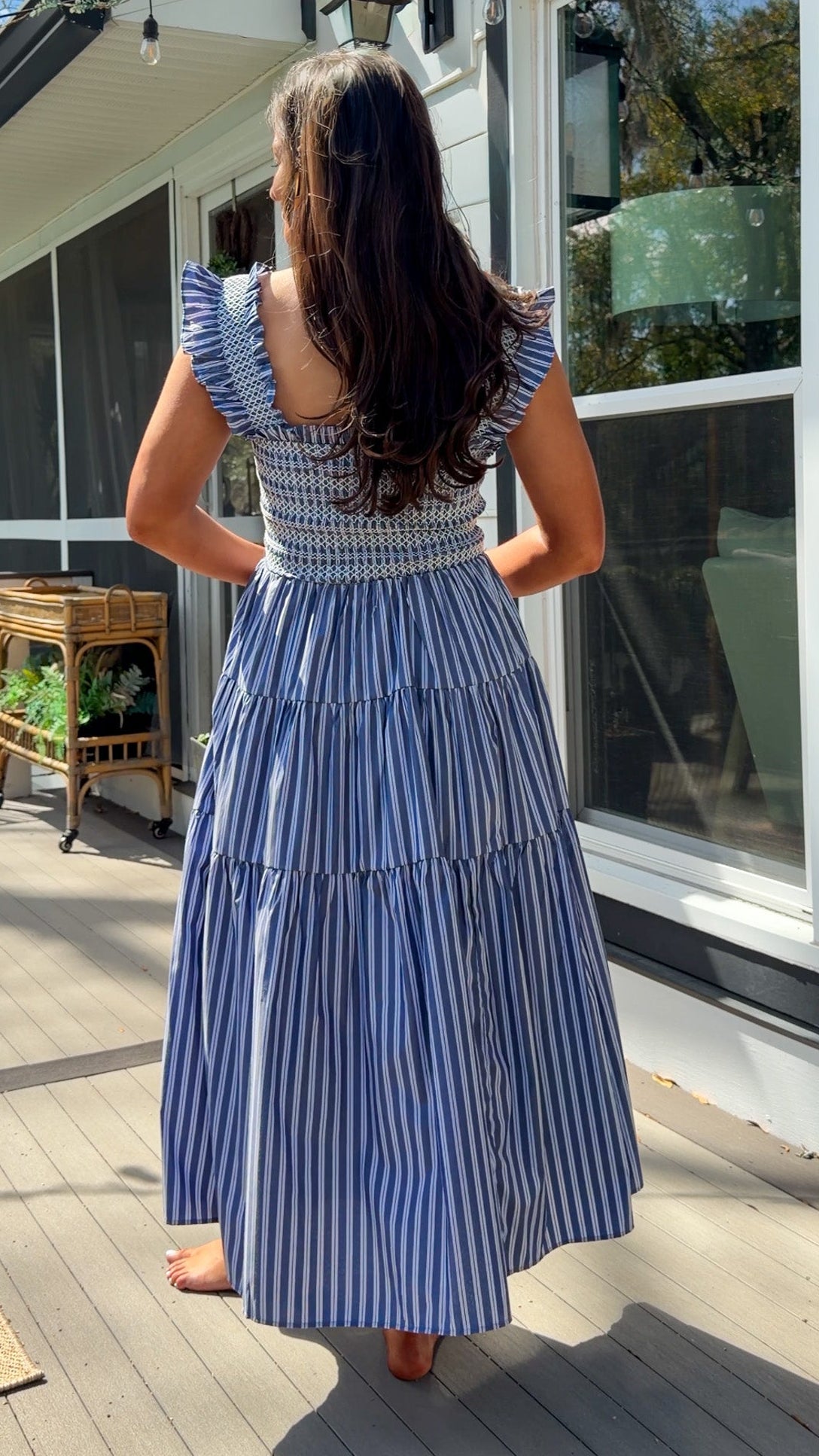 navy striped midi dress with smocked bodice ruffle sleeves and tiered skirt