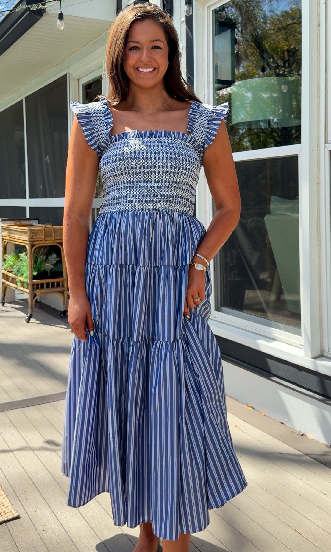 navy striped midi dress with smocked bodice ruffle sleeves and tiered skirt