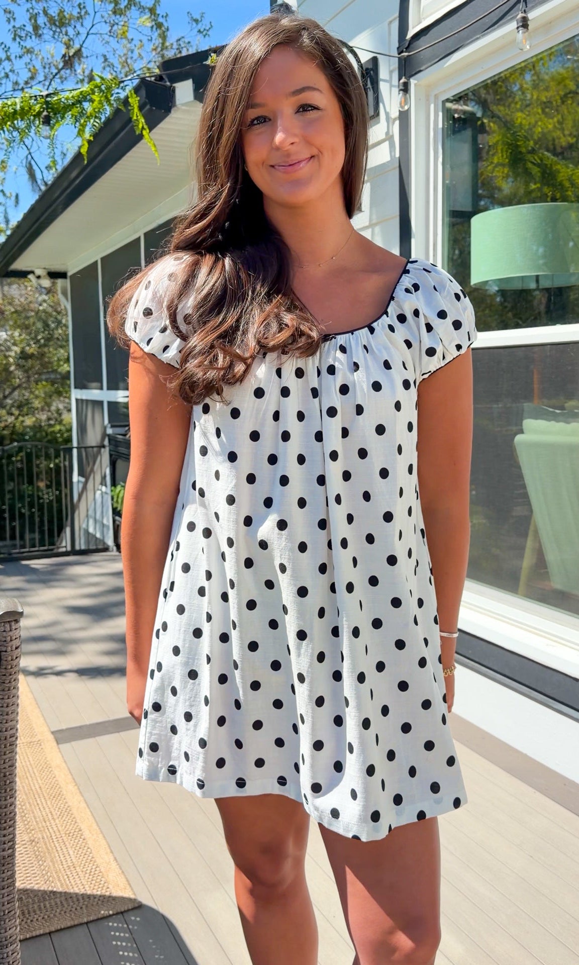 white and black polka dot mini dress with black bow