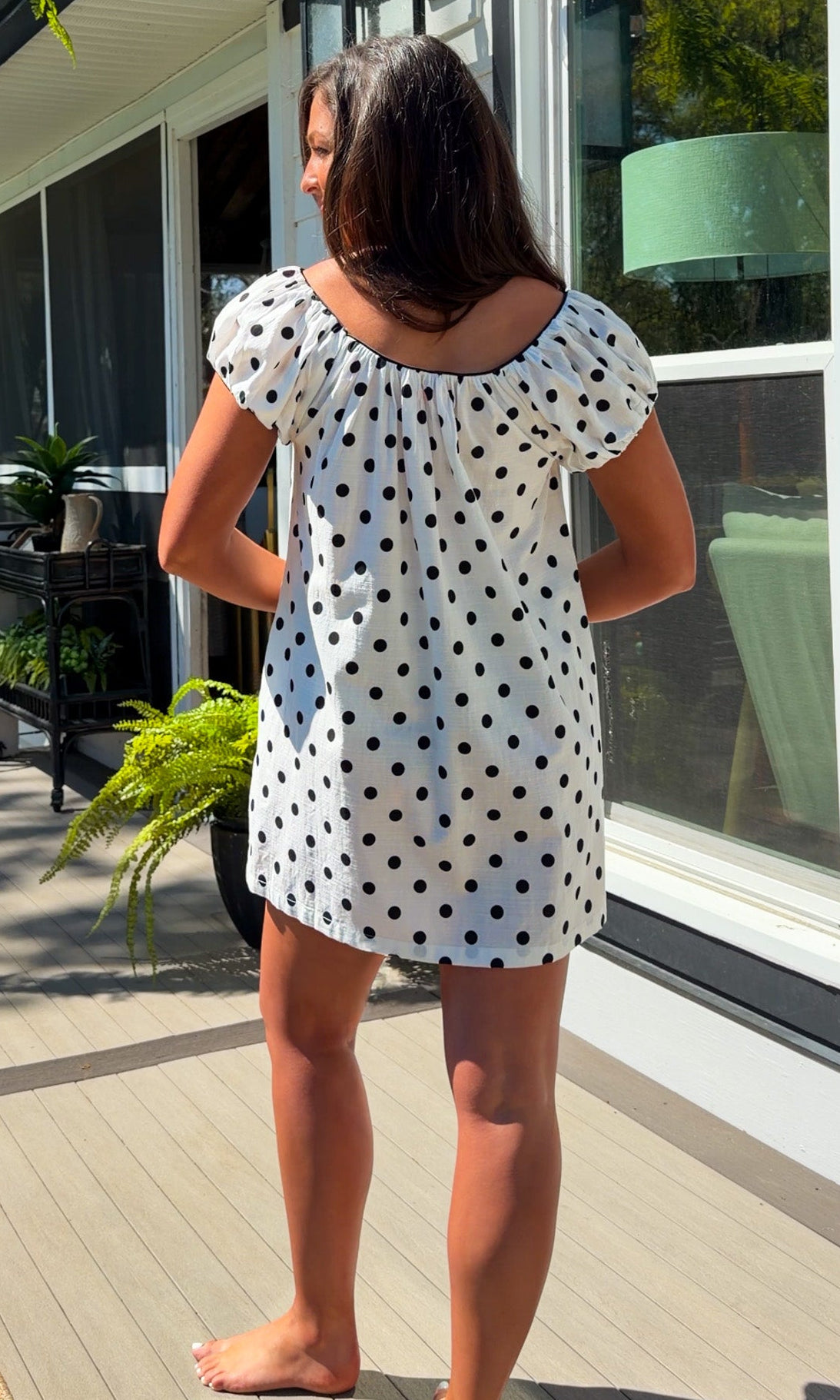white and black polka dot mini dress with black bow