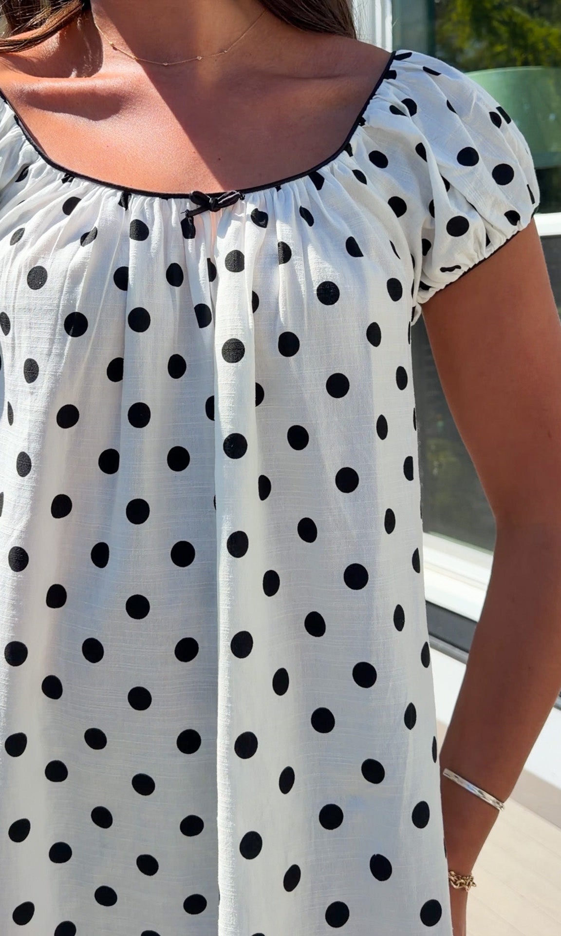 white and black polka dot mini dress with black bow