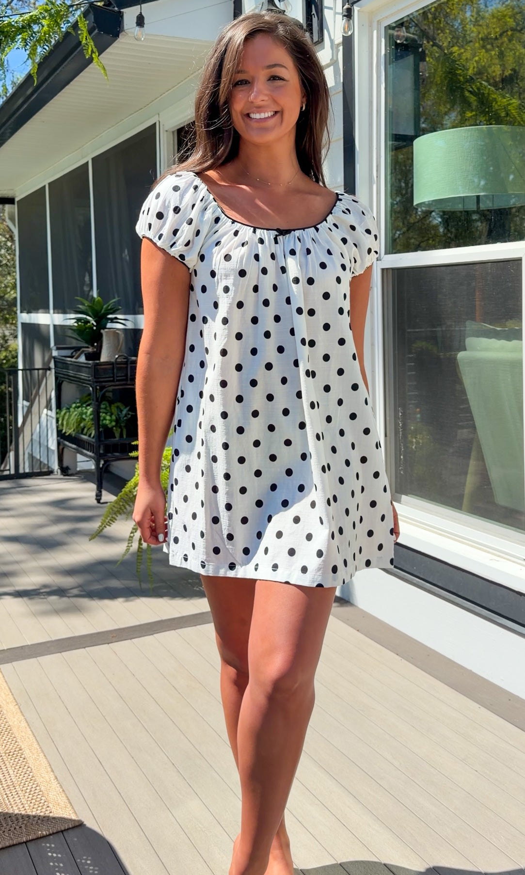 white and black polka dot mini dress with black bow