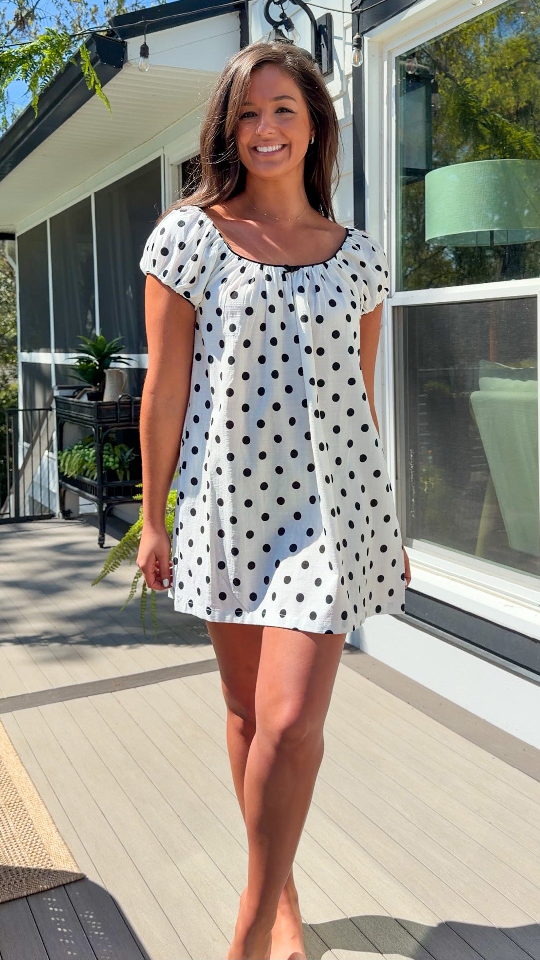 white and black polka dot mini dress with black bow