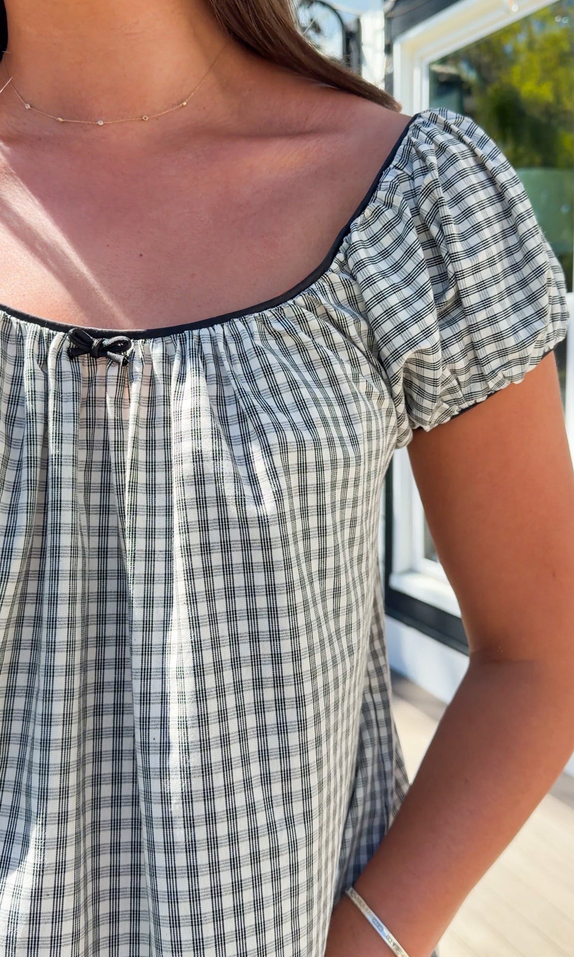 black and white gingham mini dress with cap sleeves and bow