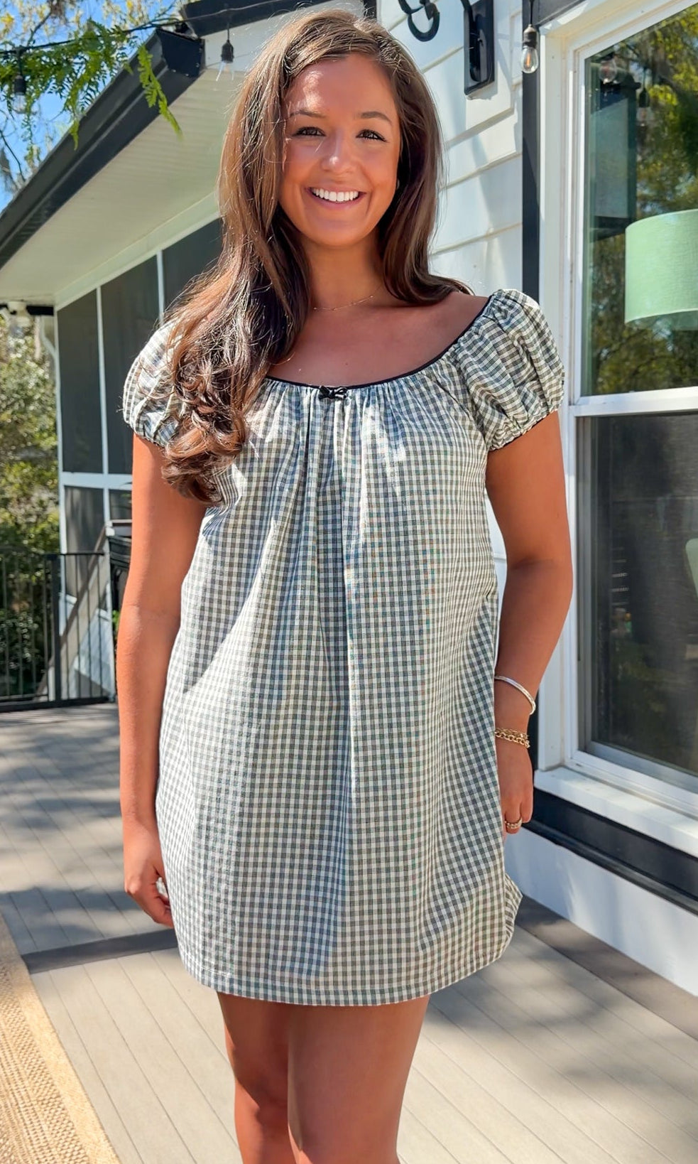 black and white gingham mini dress with cap sleeves and bow