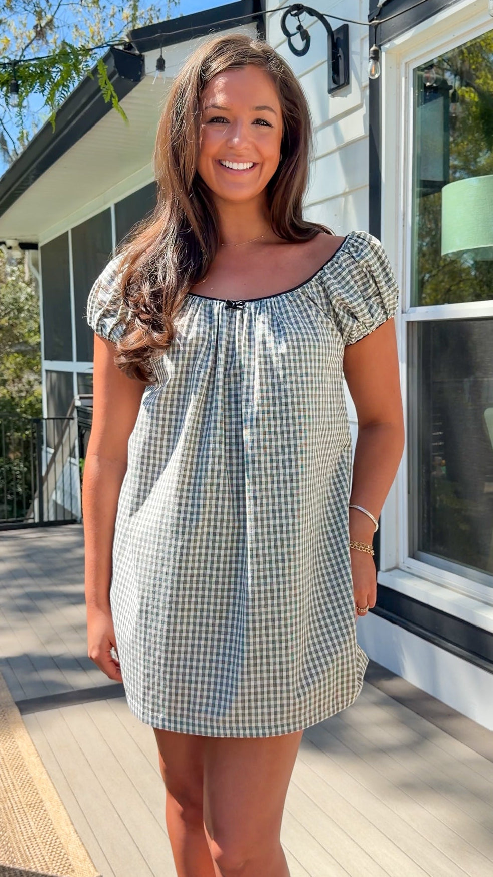 black and white gingham mini dress with cap sleeves and bow
