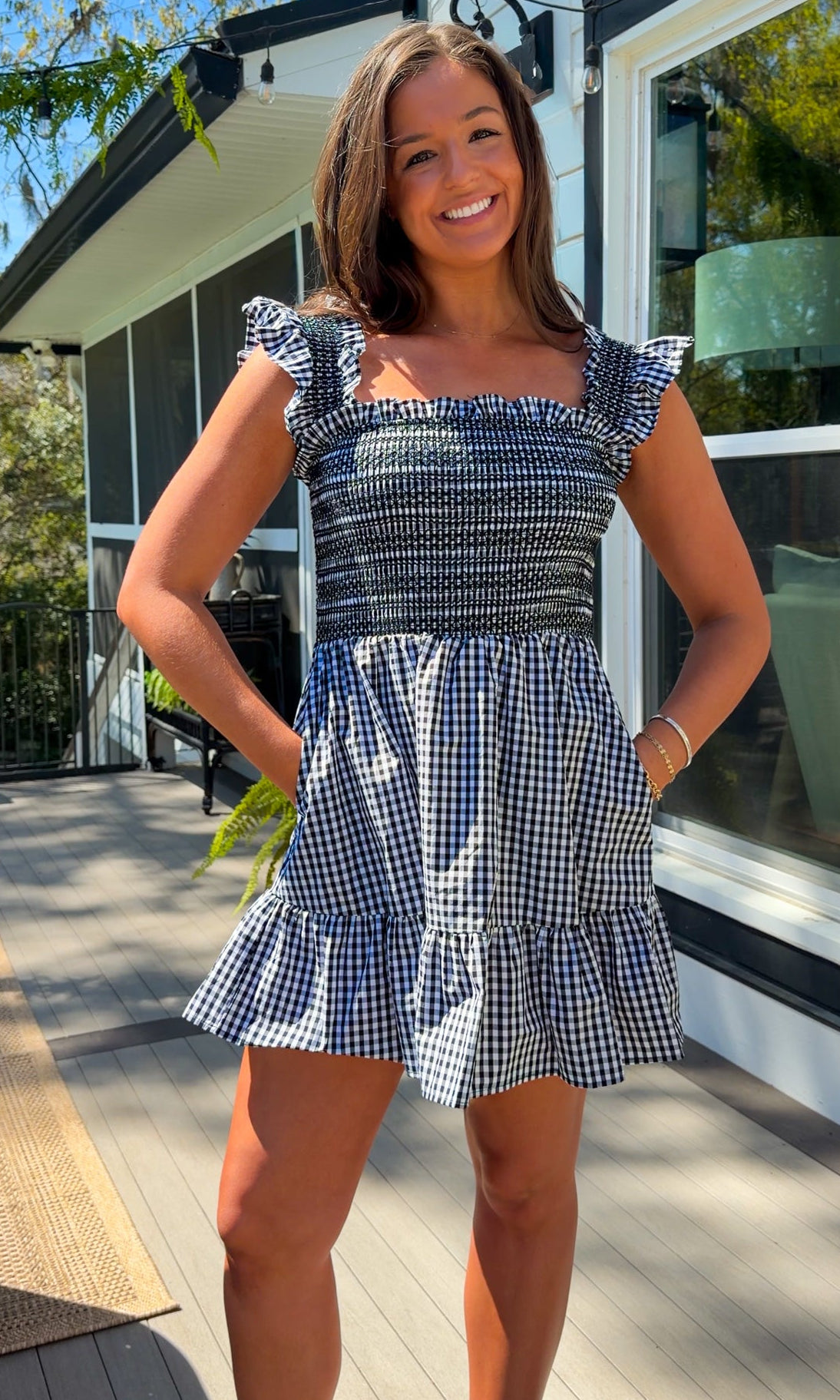 black and white gingham smocked mini dress with ruffle straps and flowy skirt and built in shorts