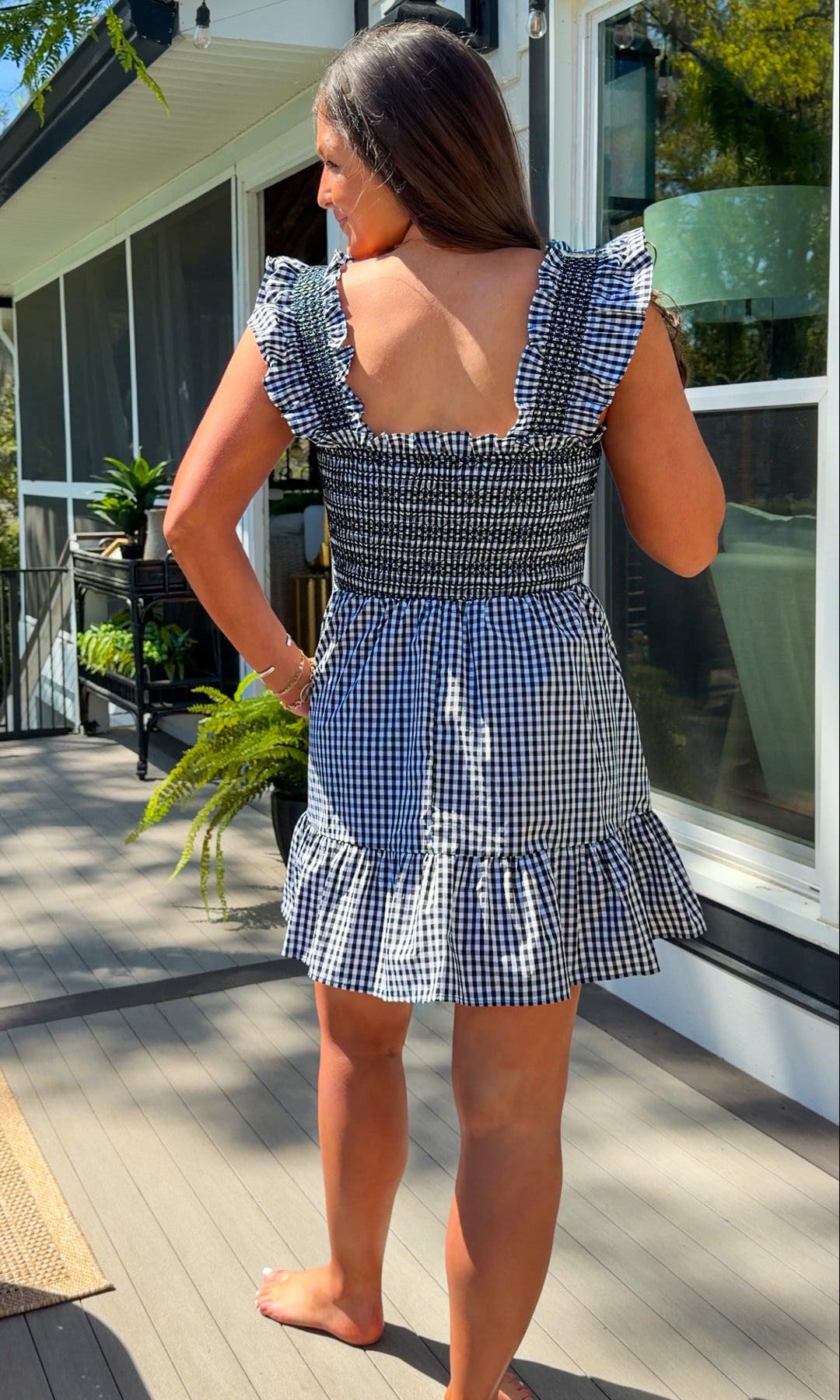 black and white gingham smocked mini dress with ruffle straps and flowy skirt and built in shorts