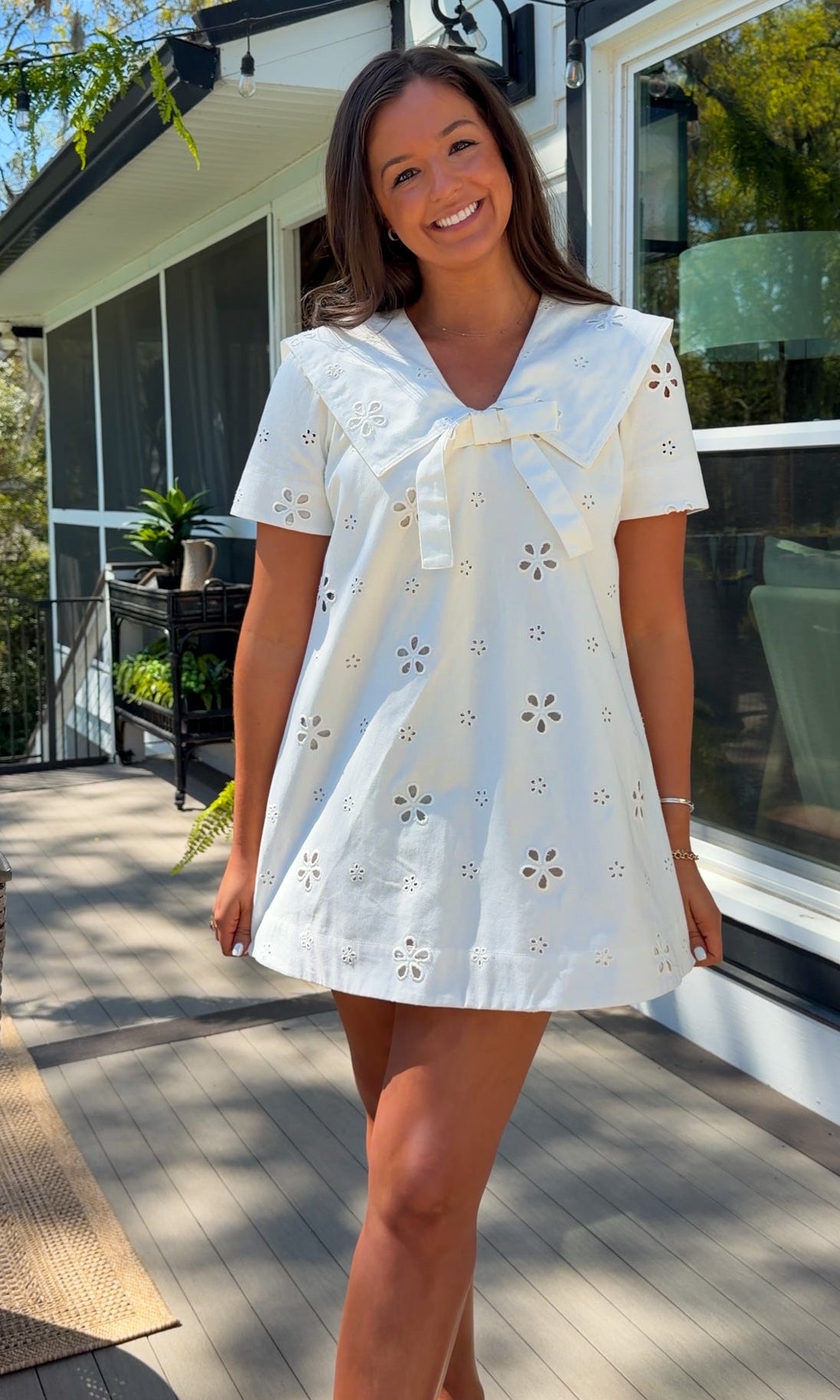 white eyelet mini dress with sailor collar bow tie detail and short sleeves