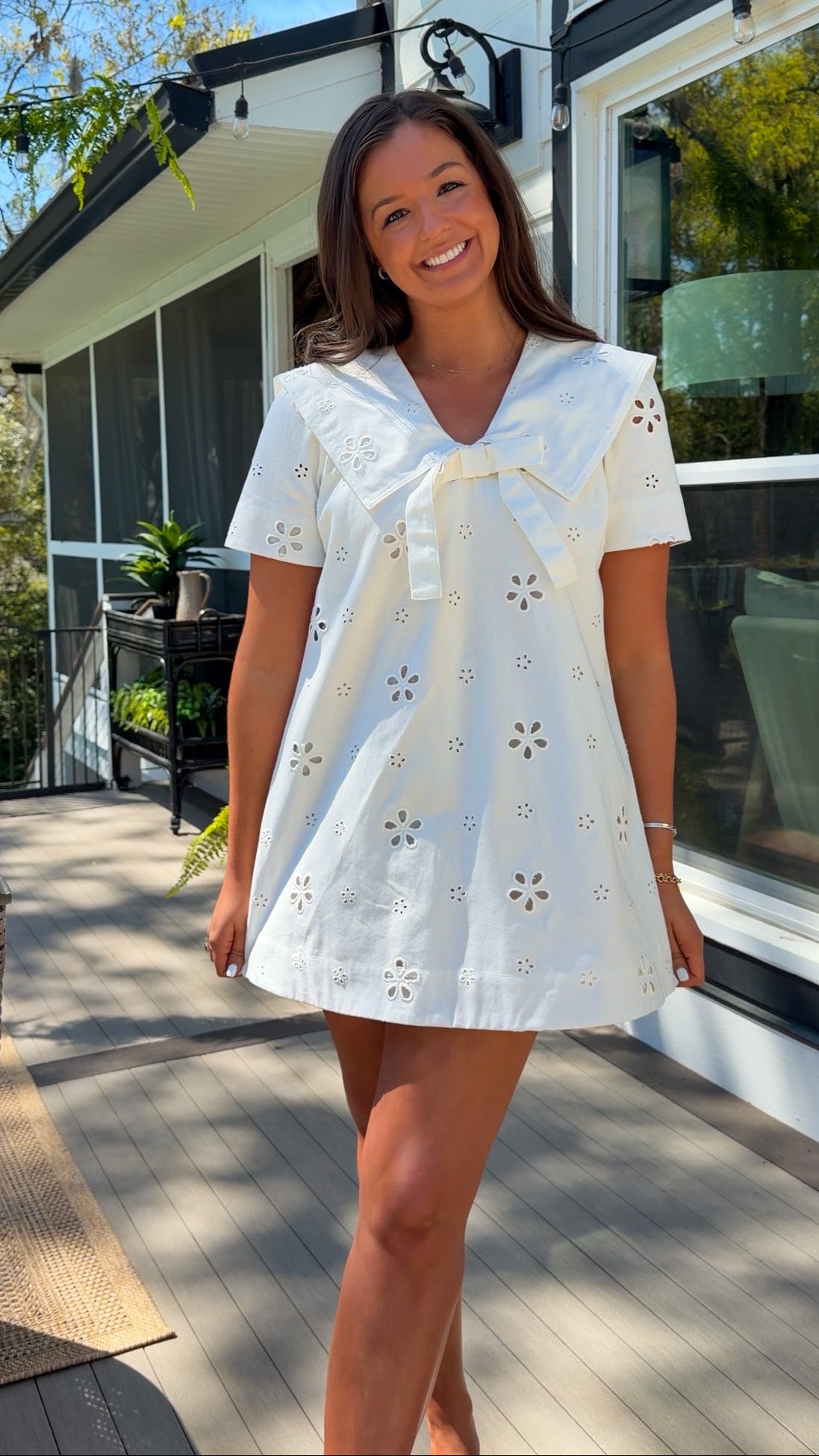 white eyelet mini dress with sailor collar bow tie detail and short sleeves