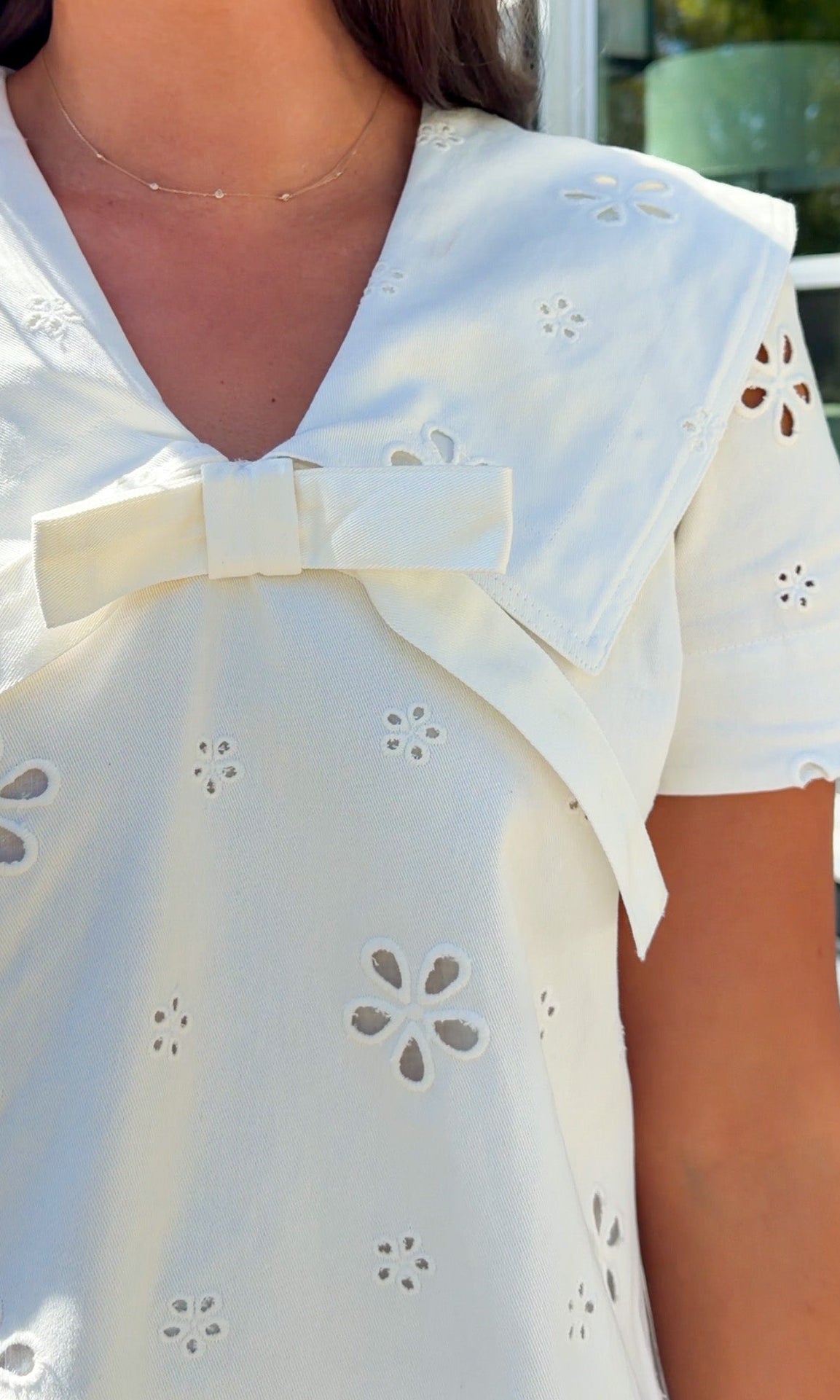 white eyelet mini dress with sailor collar bow tie detail and short sleeves