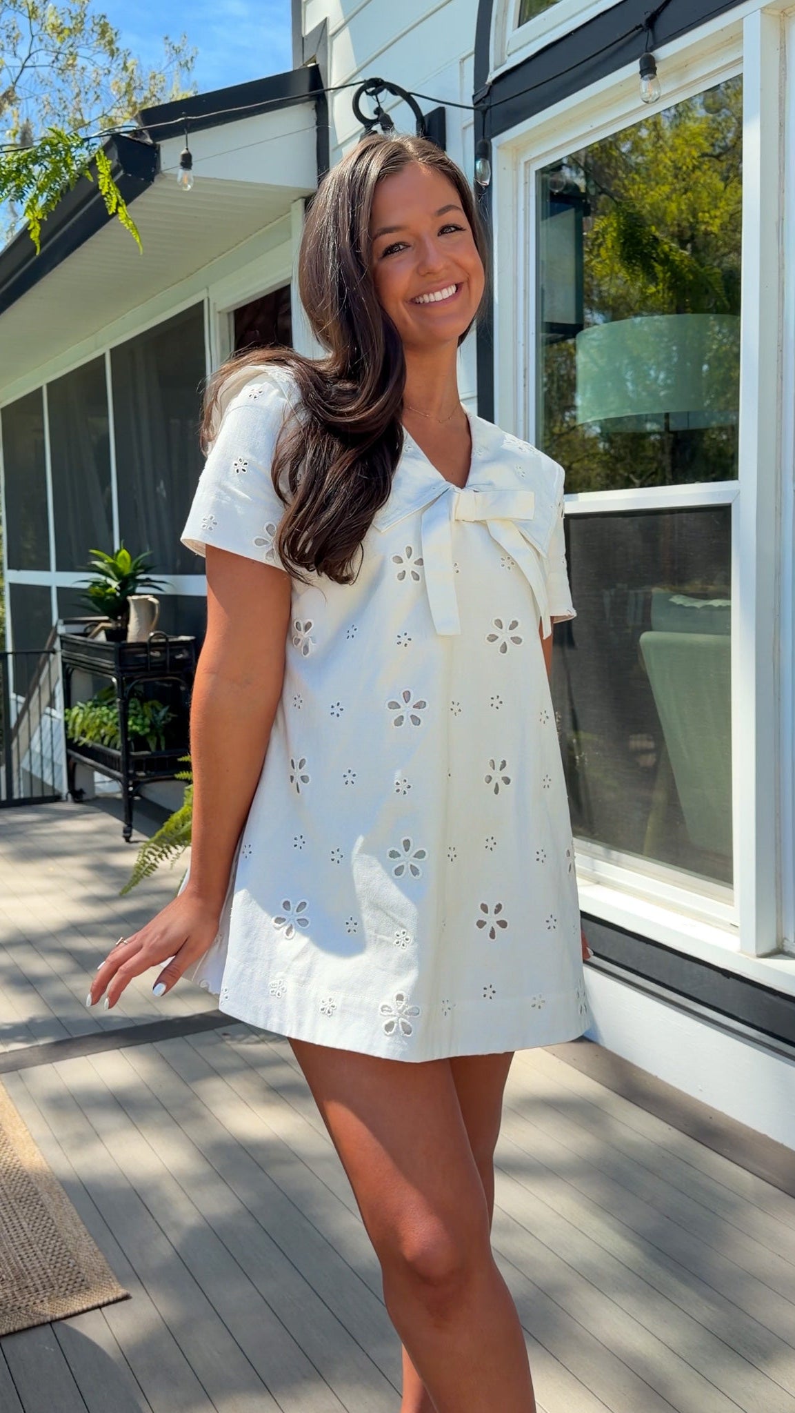 white eyelet mini dress with sailor collar bow tie detail and short sleeves
