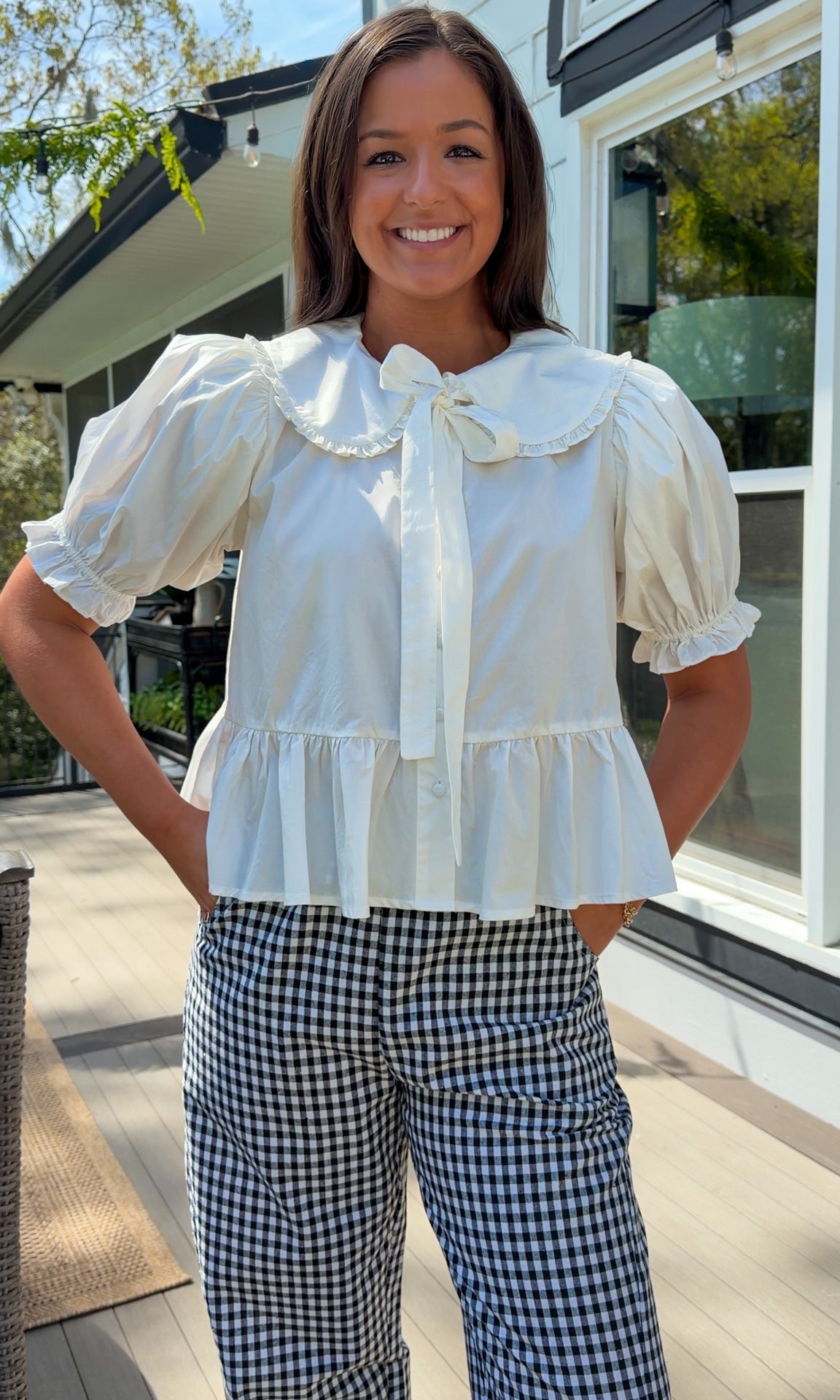 white cotton blouse with peter pan collar, puff sleeves, tie front bow and peplum hem