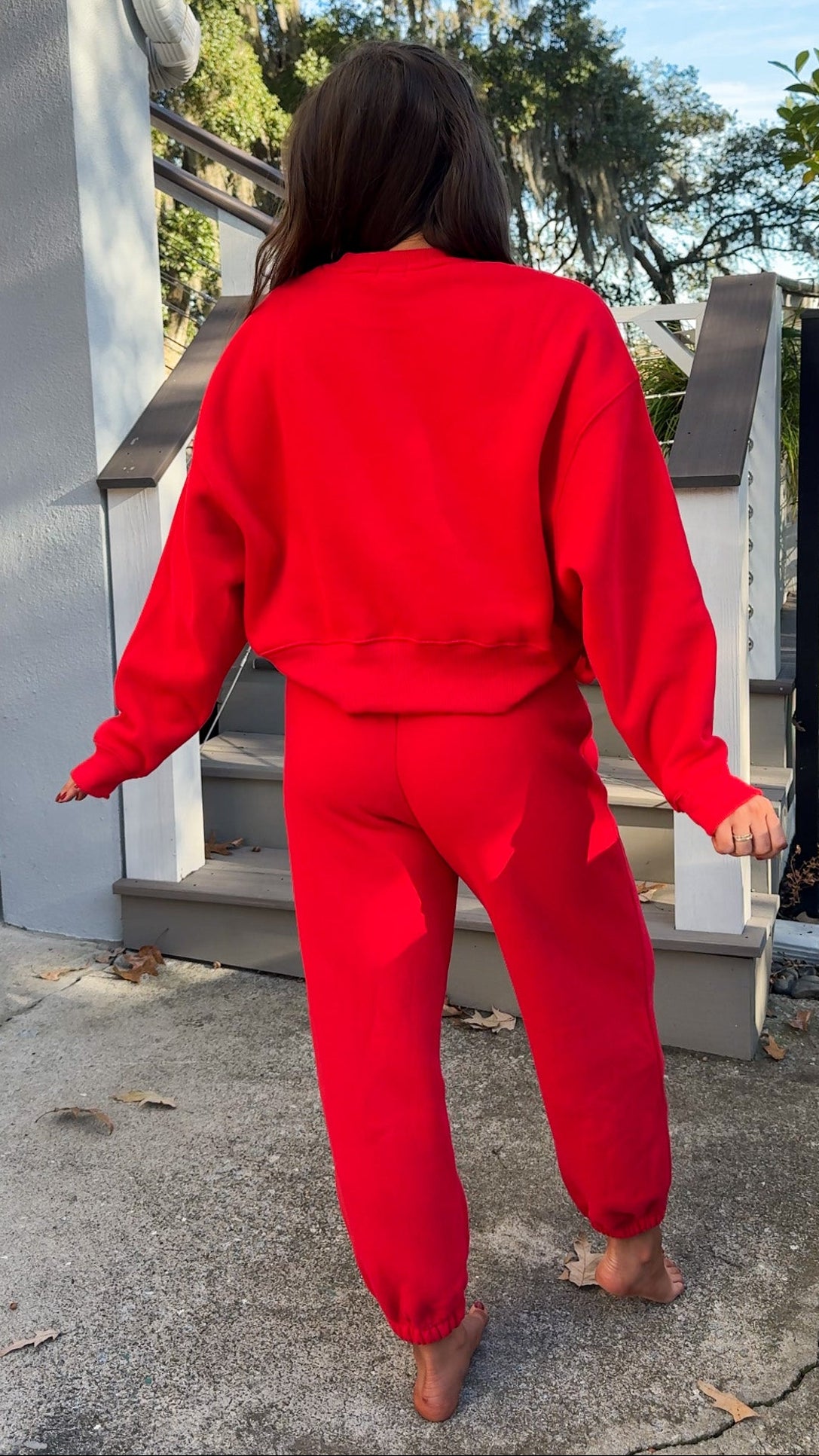 matching red sweatpants and sweatshirt comfy cozy loungewear. elastic waist band and slightly cropped oversized long sleeve top back