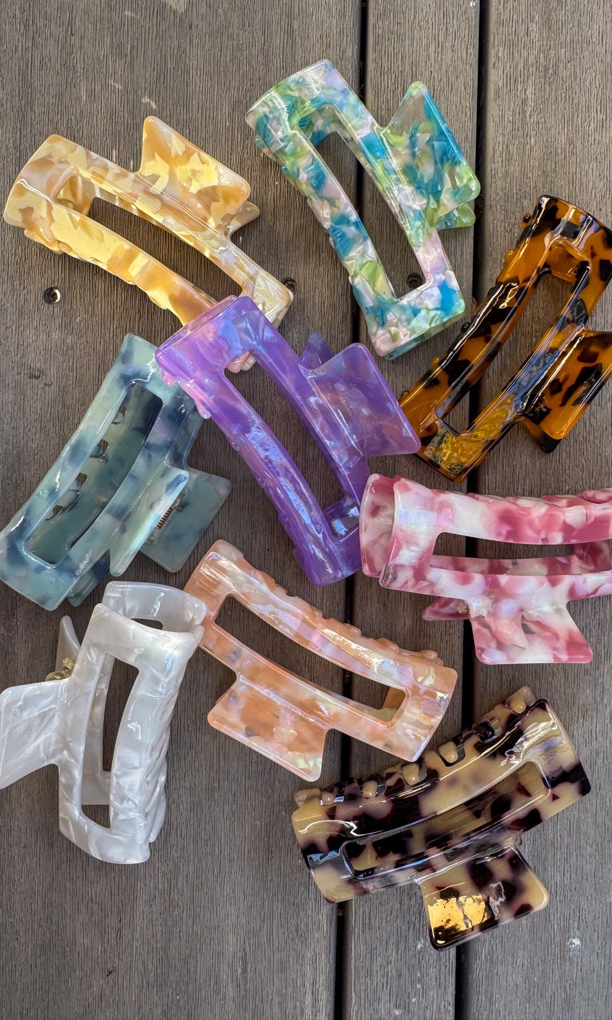 Colorful hair clips on a wooden surface