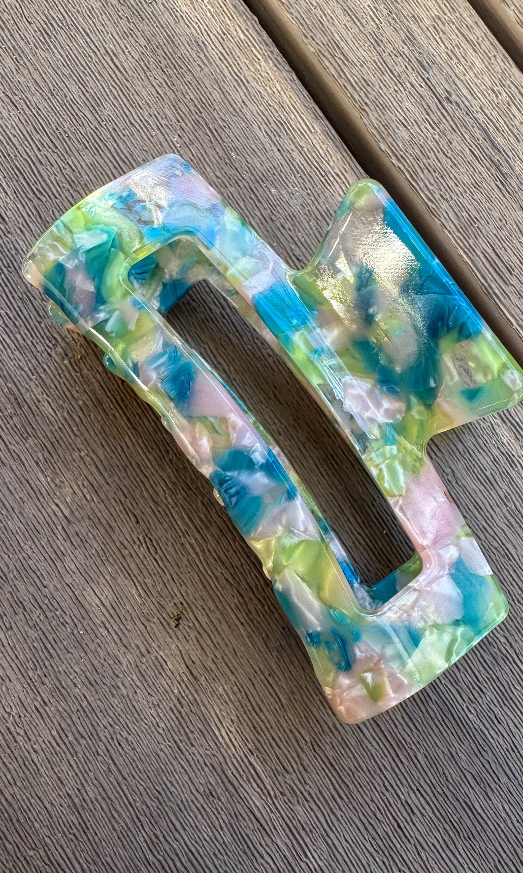 Colorful plastic buckle on a wooden surface