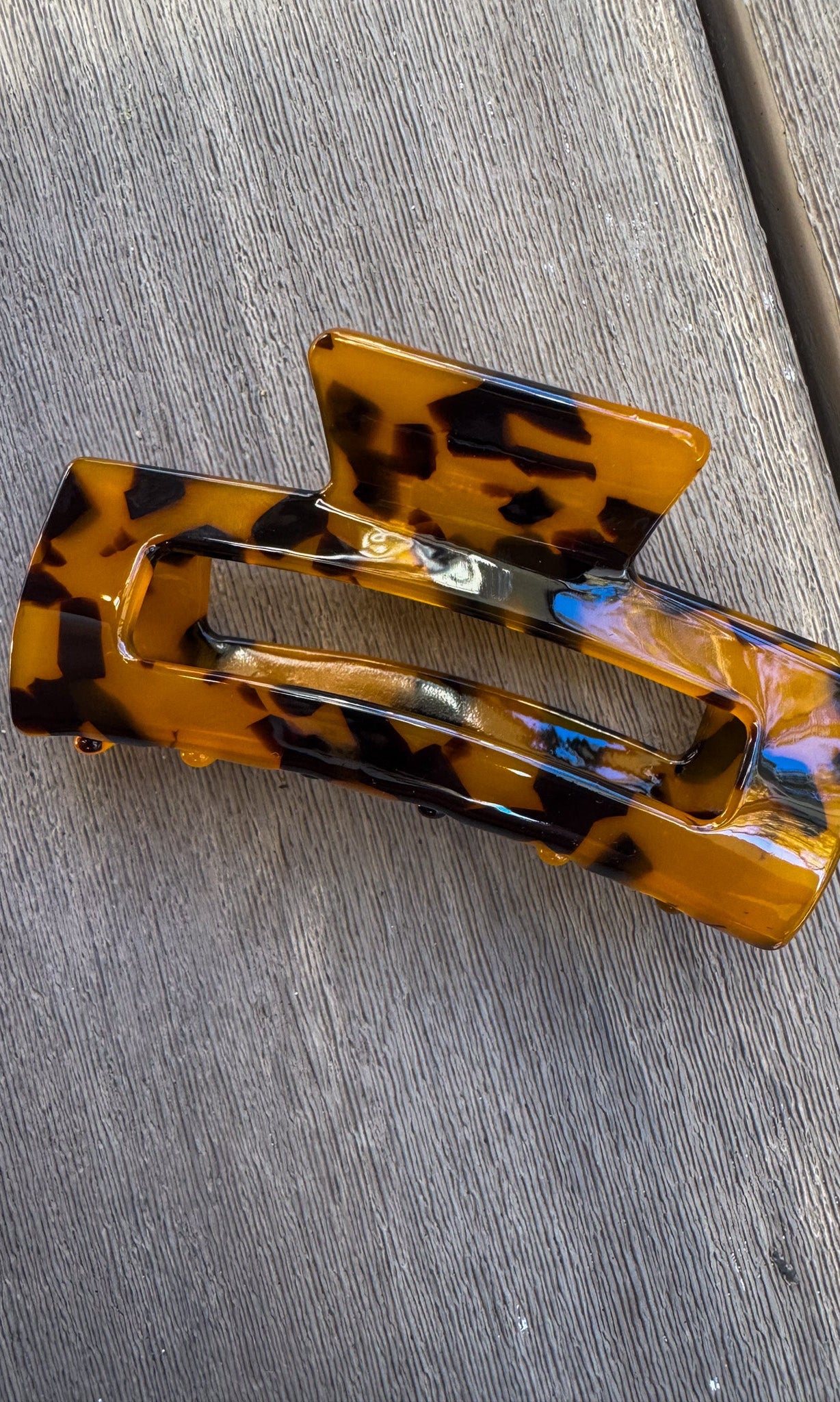 Tortoiseshell hair clip on a gray surface