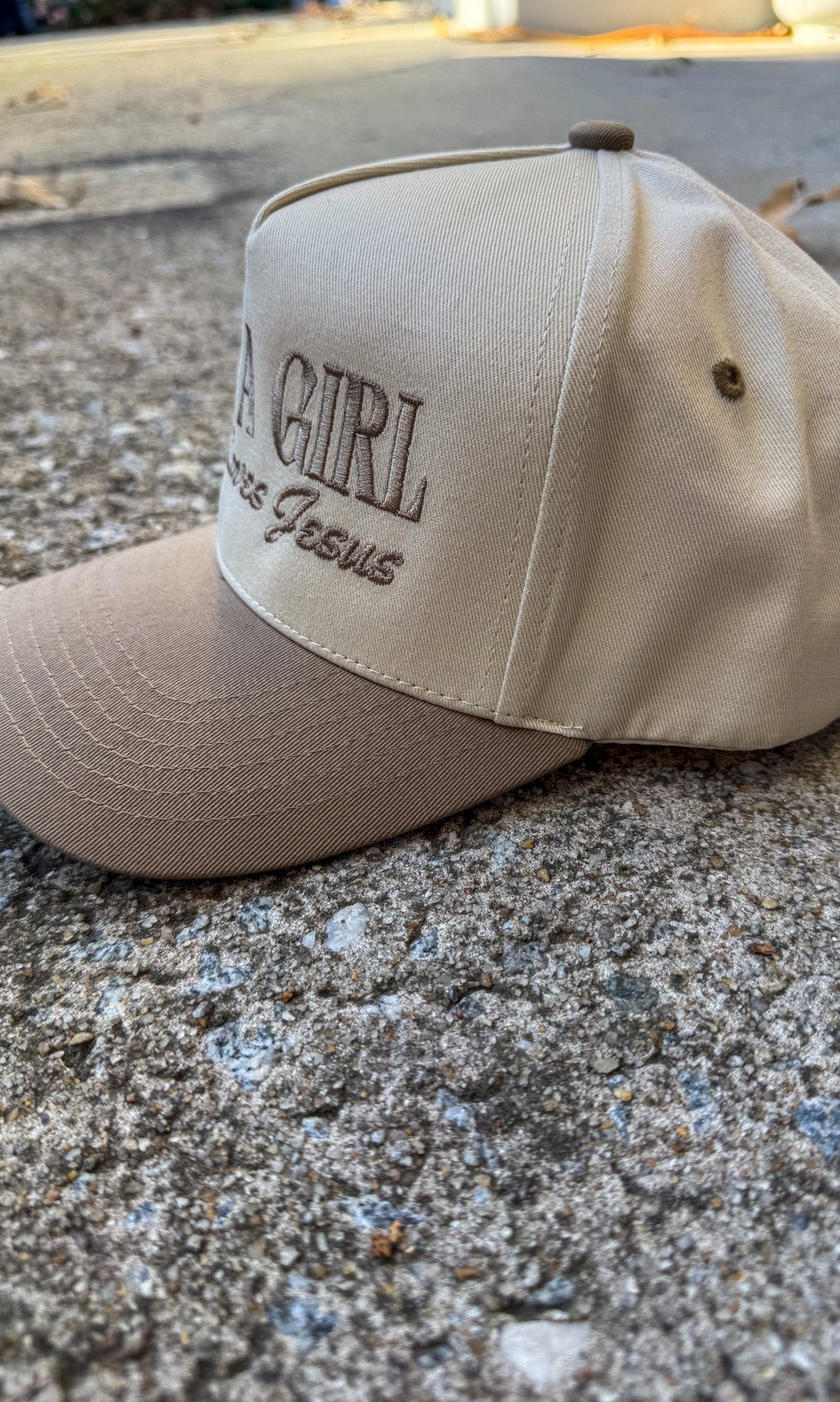 Beige cap with text on a concrete surface