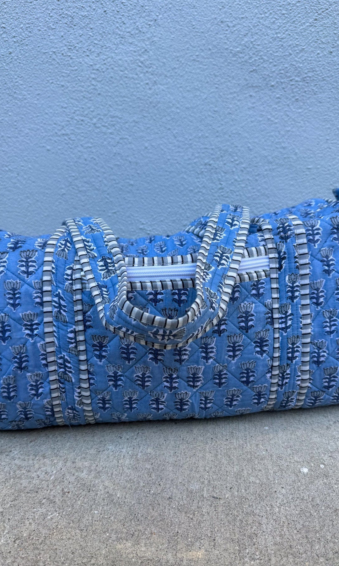 blue quilted block print duffle bag