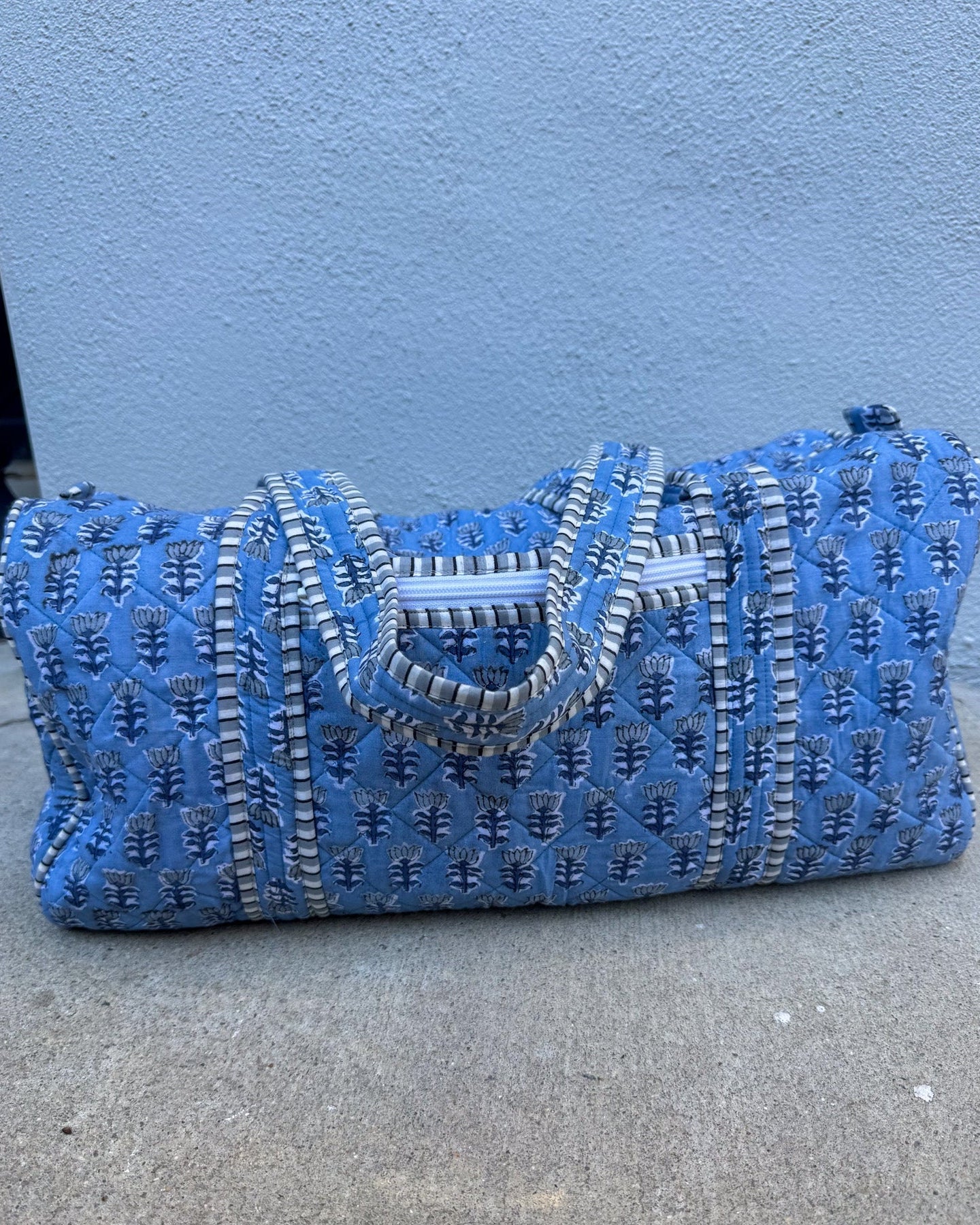 blue quilted block print duffle bag